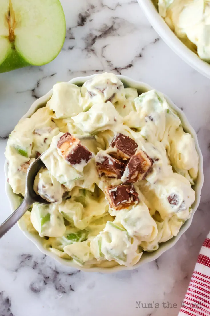 spoon scooping out a portion of the snickers apple salad