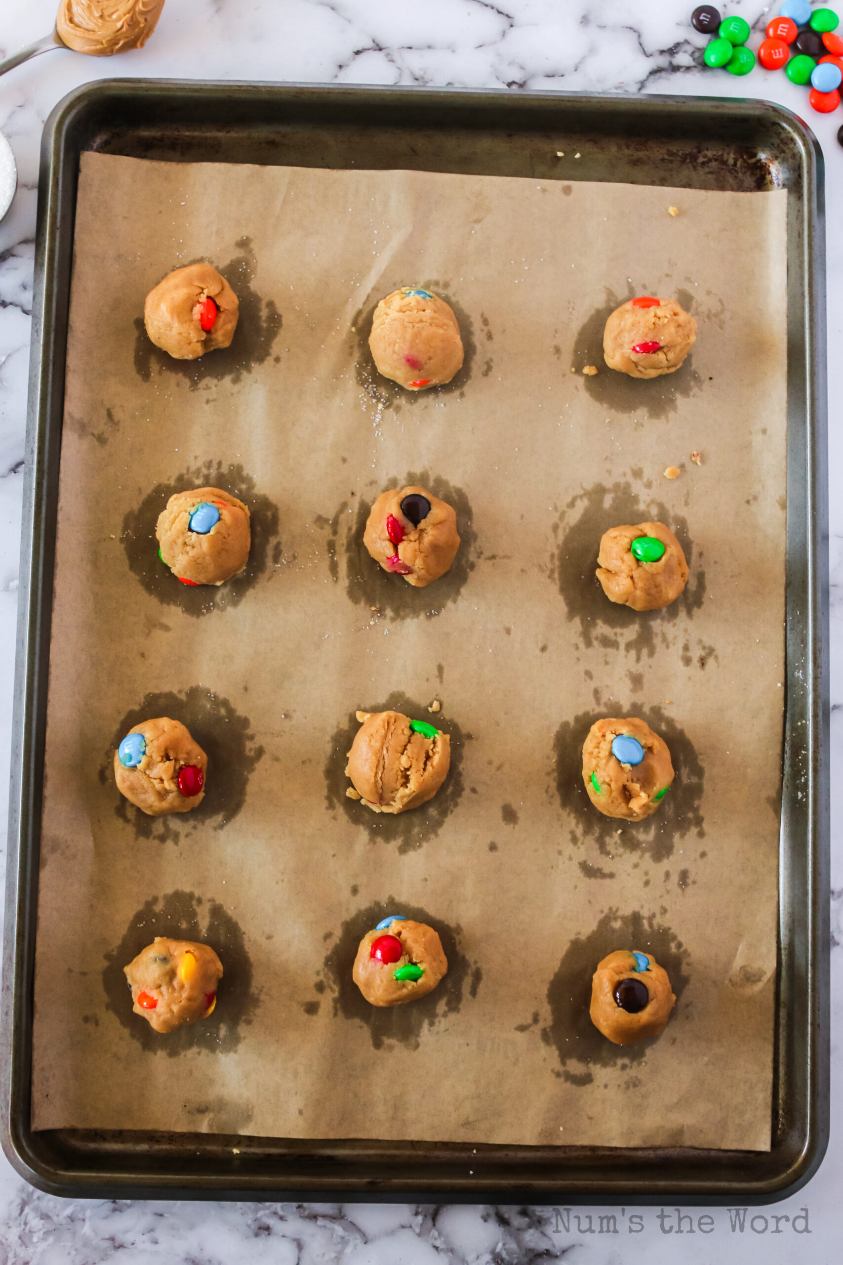 cookie dough balls on baking sheet, ready for the oven