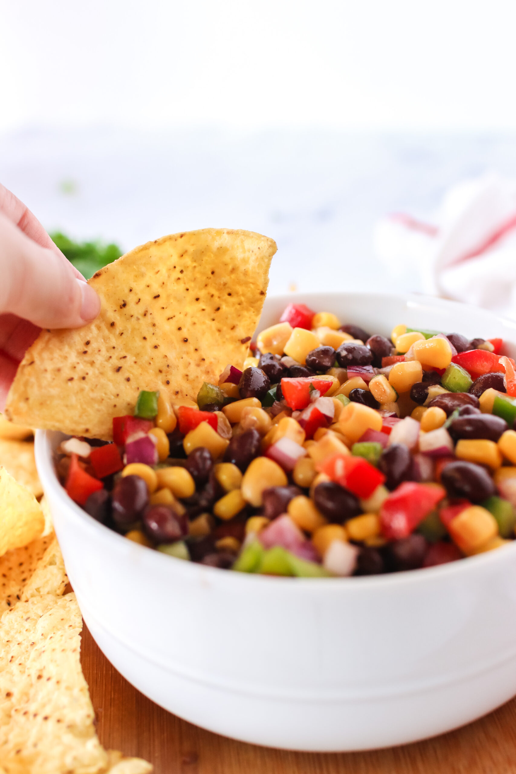 close up of chip dipping into black bean salsa