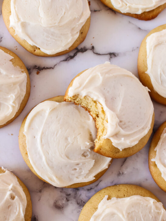 zoomed in image of cookies on counter with a bite removed from one cookie