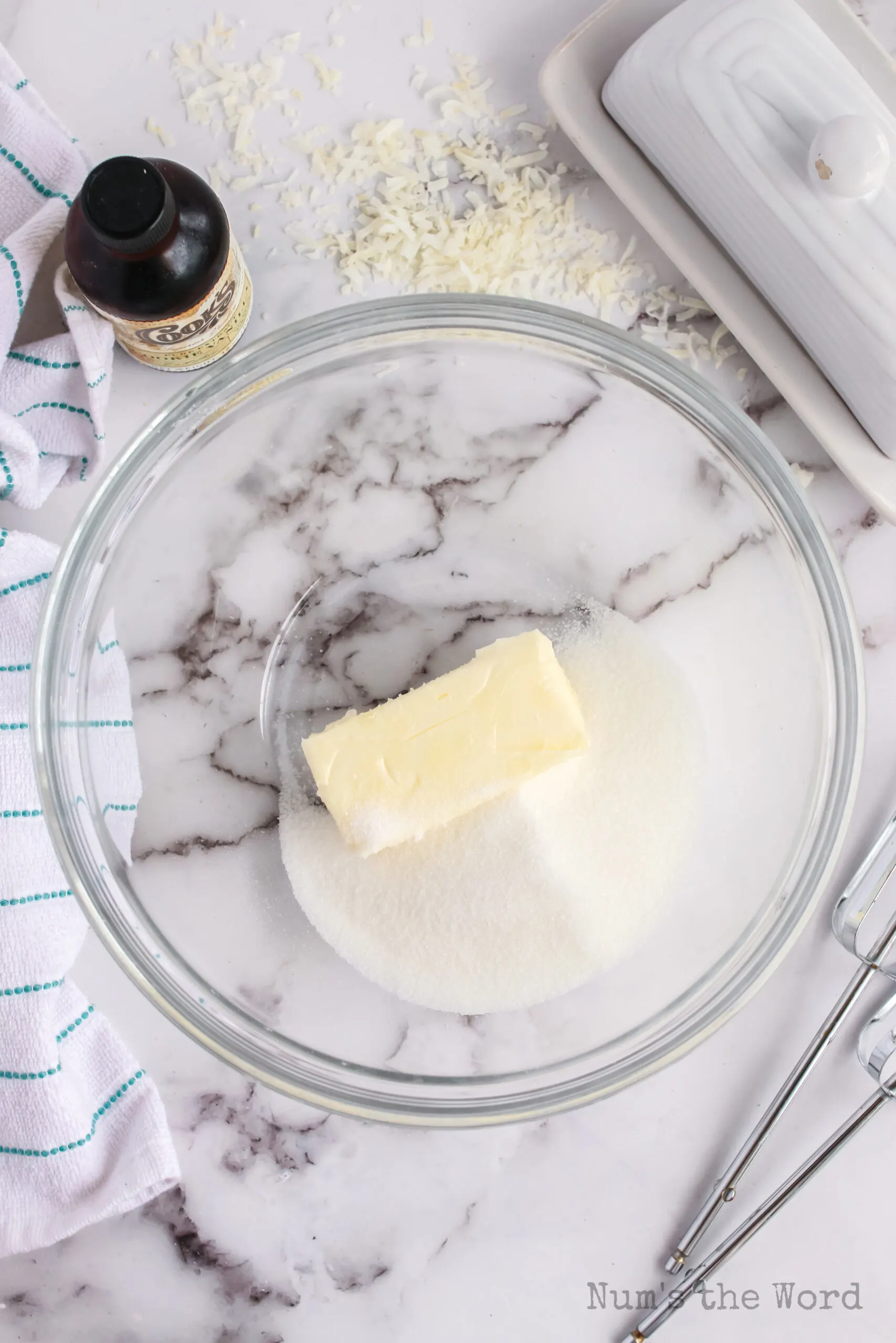 Butter and white sugar in a bowl, ready to be creamed.