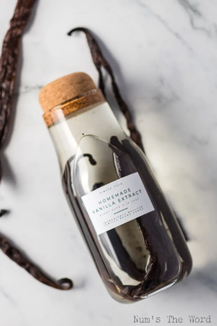 bottle of single fold vanilla extract laid out on counter.