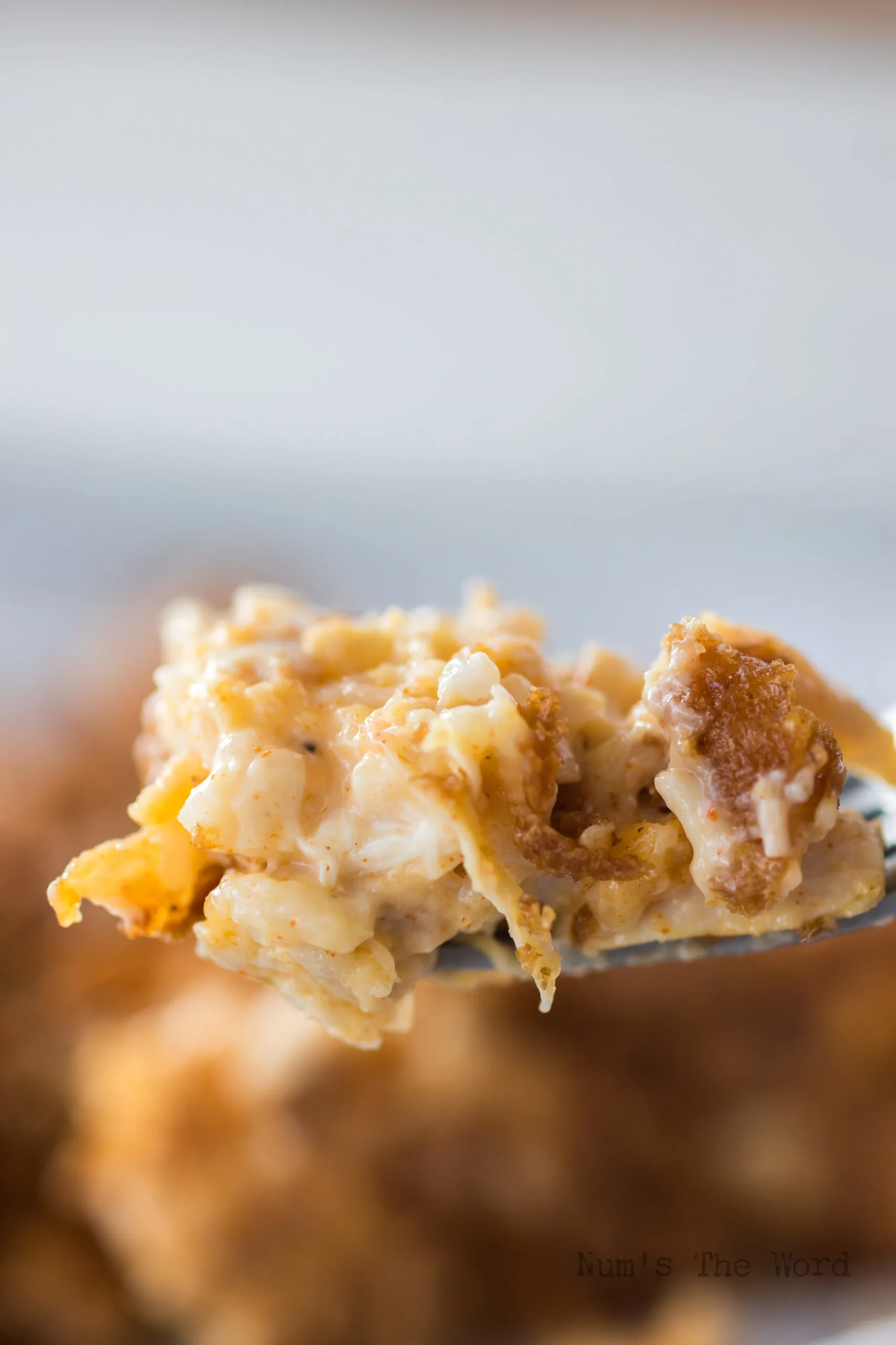 fork holding up a portion of yummy chicken and rice casserole with cornflakes