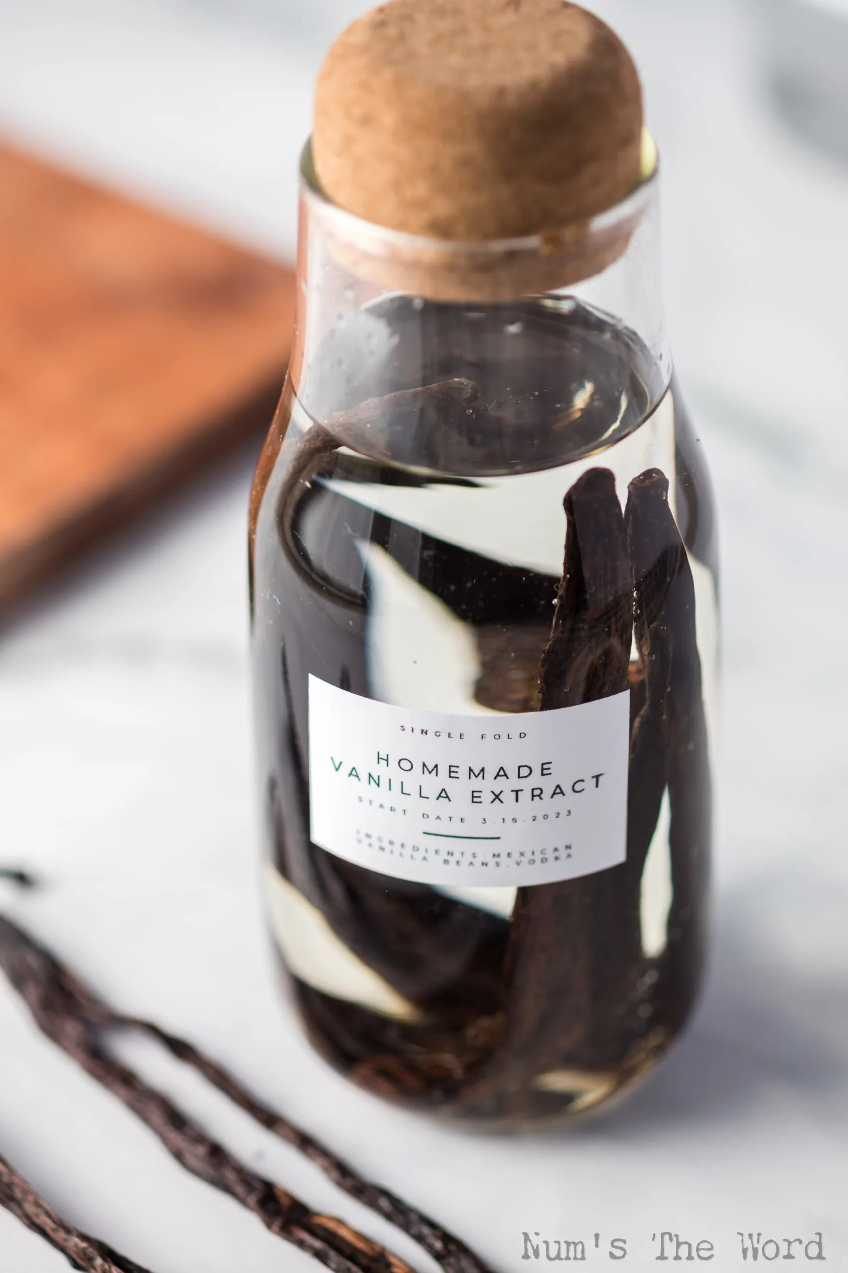 zoomed in image of single fold vanilla extract in bottle
