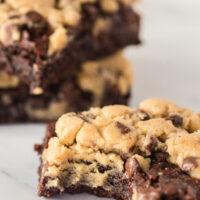 3 cookie dough brownies on counter. One brownie has a bite removed