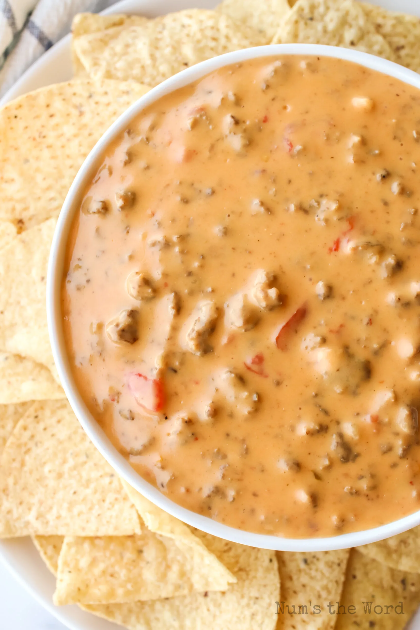 sausage dip in a bowl with chips all around