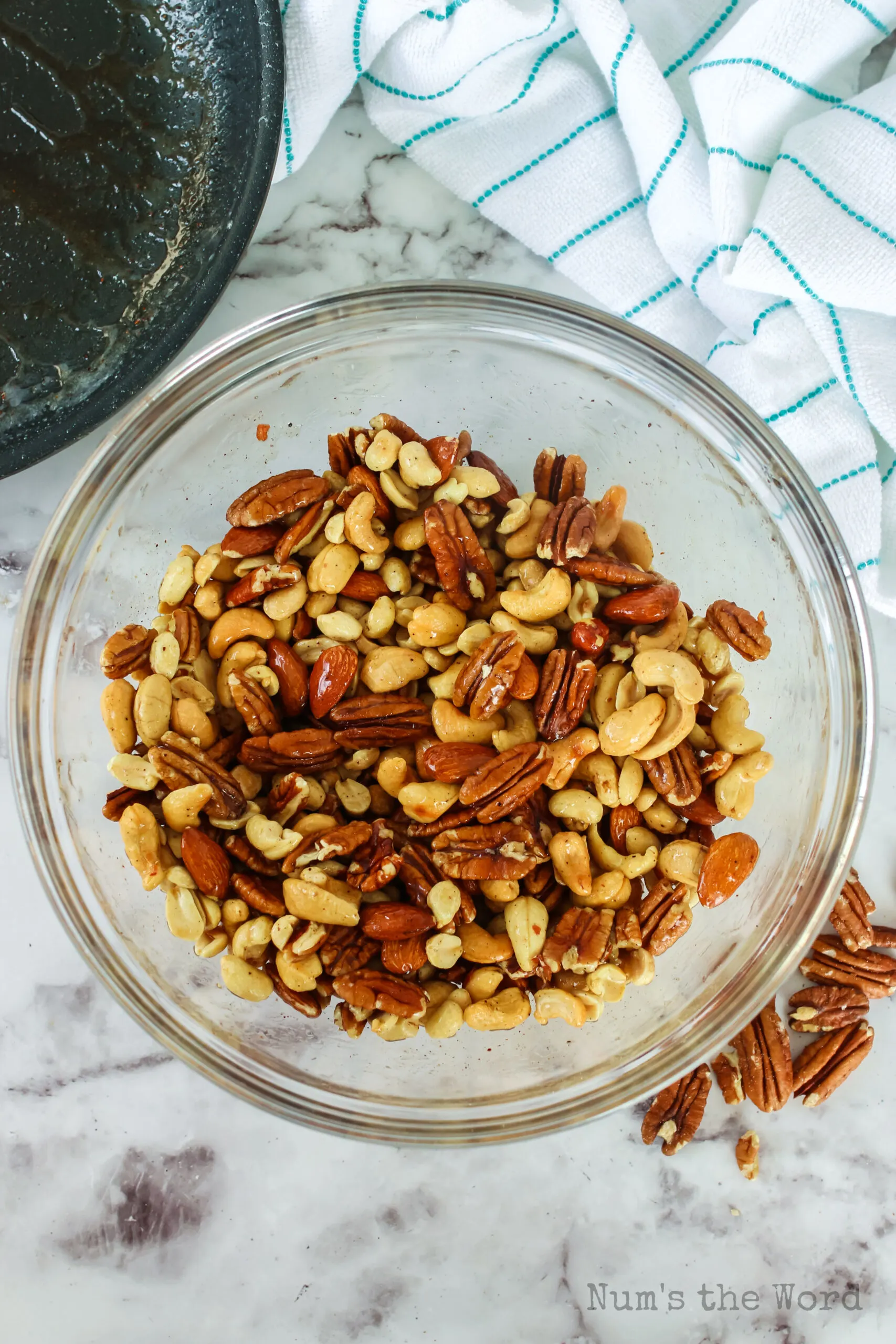 almonds, pecans, peanuts and cashews in a bowl, mixed.