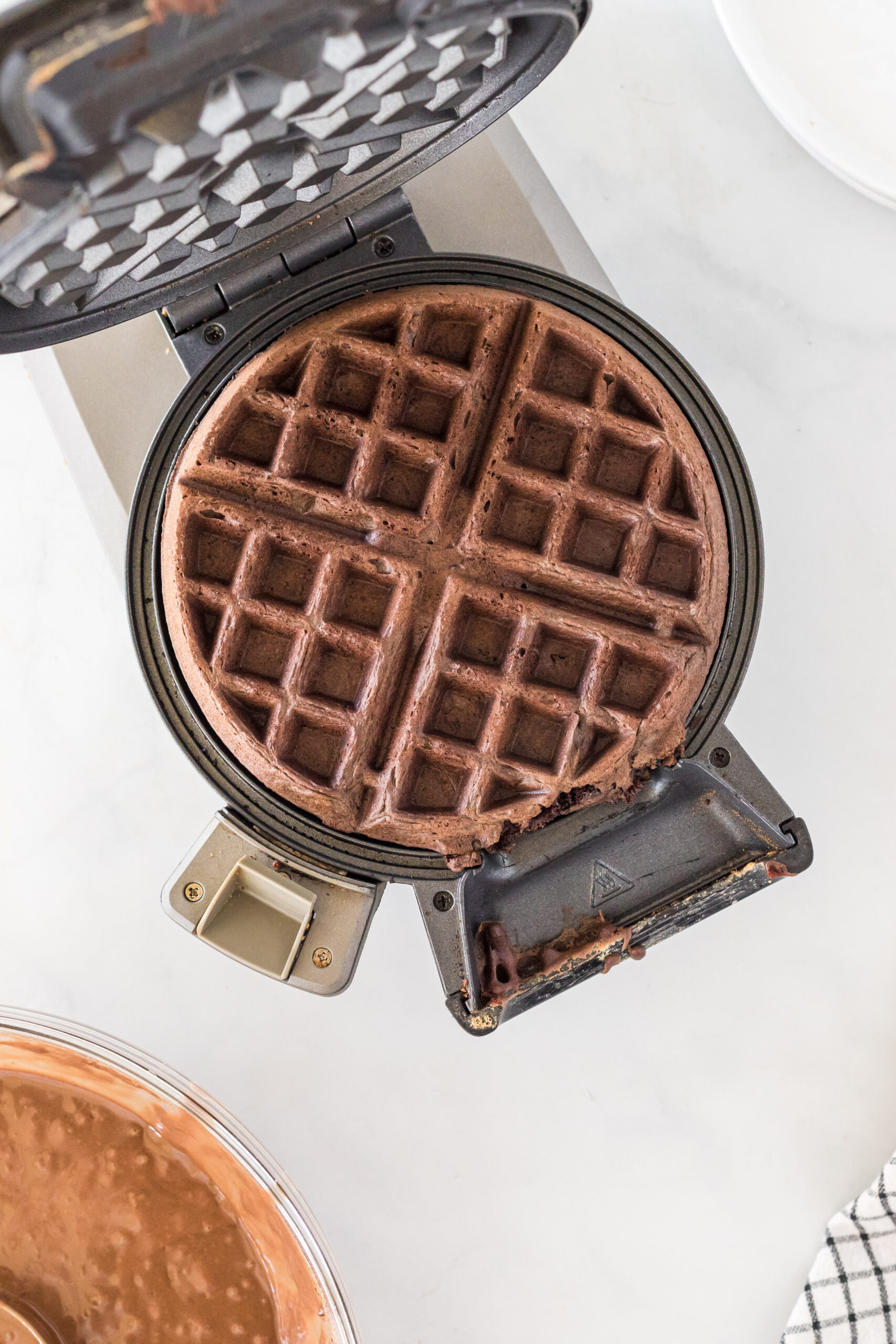Cooked waffle in a waffle iron