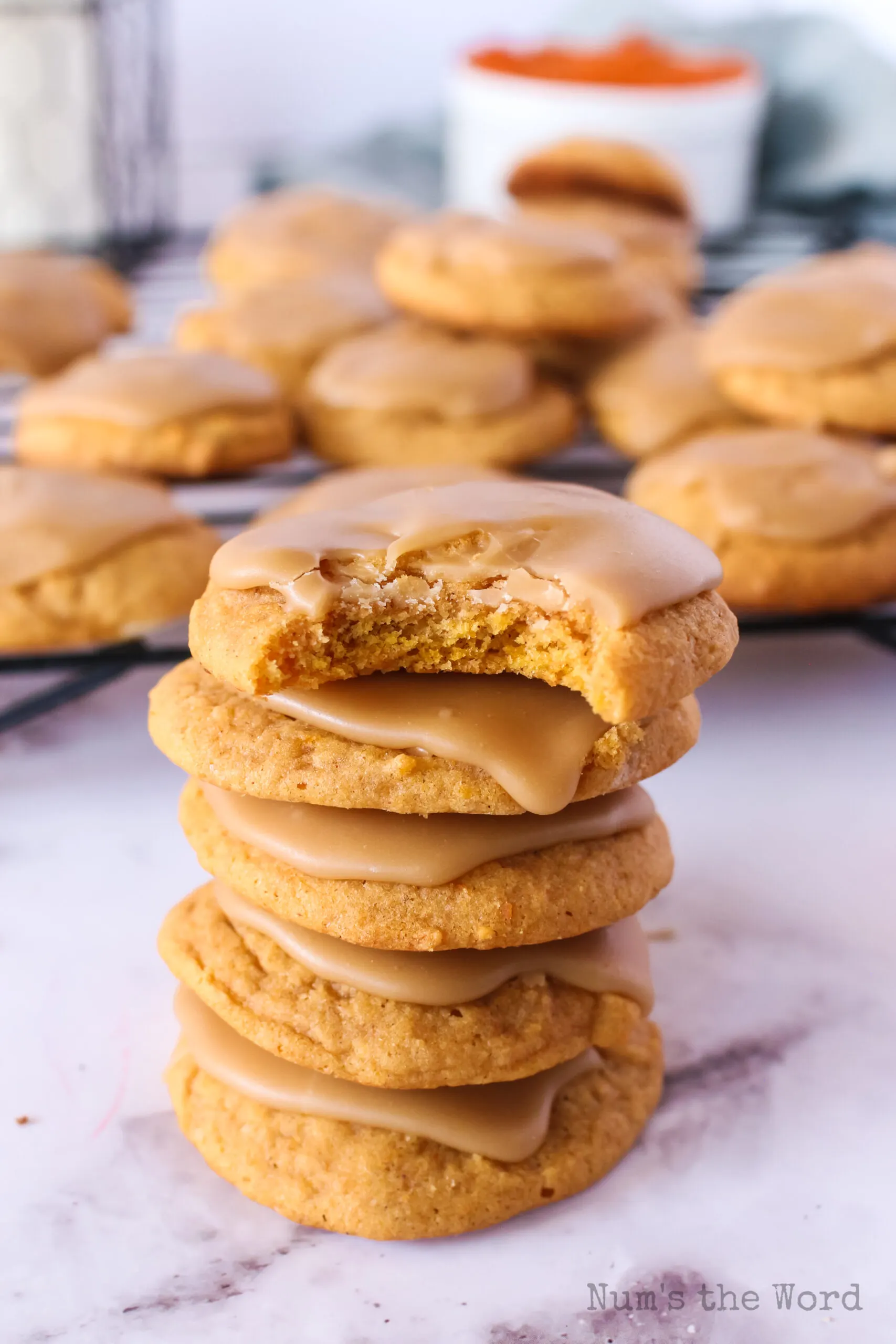 5 cookies stacked on top of each other with the top cookie having a bite removed.