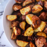 top view looking down of roasted garlic red potatoes in bowl