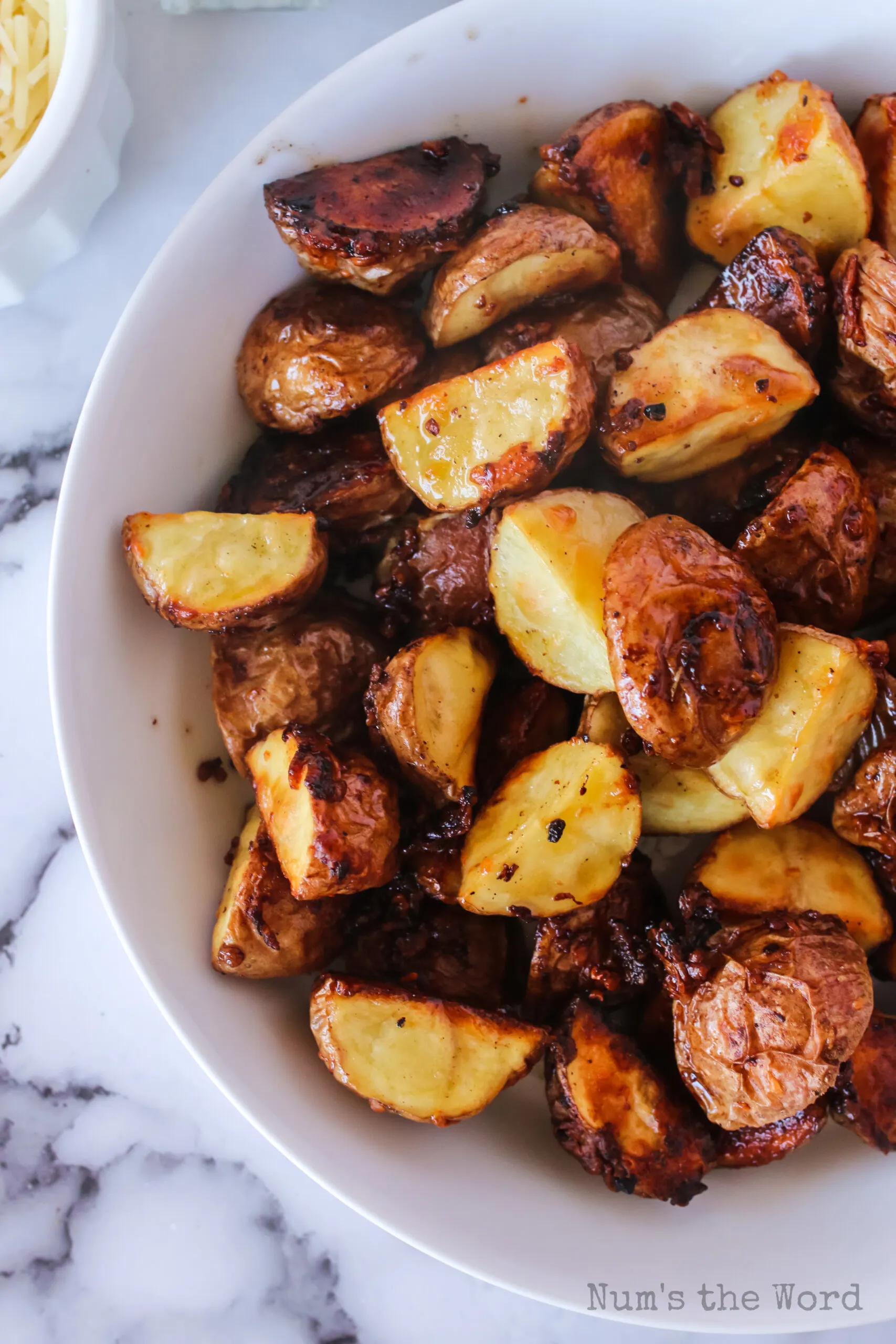 top view looking down of roasted garlic red potatoes in bowl