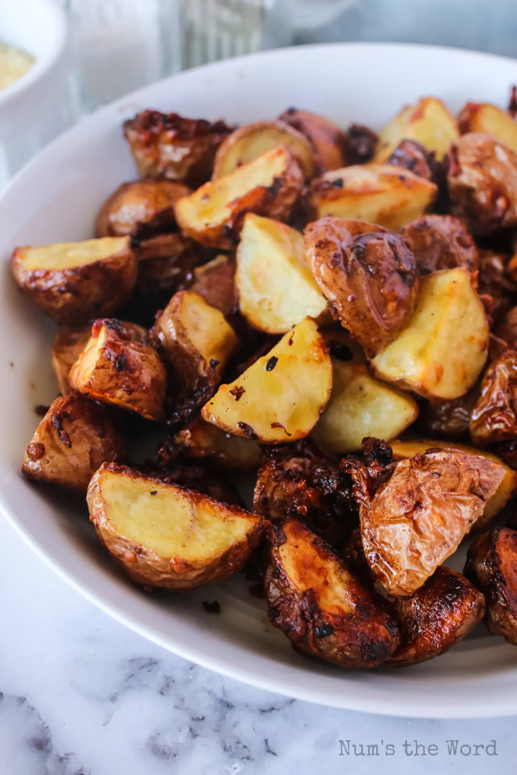 side view of roasted potatoes in a serving bowl