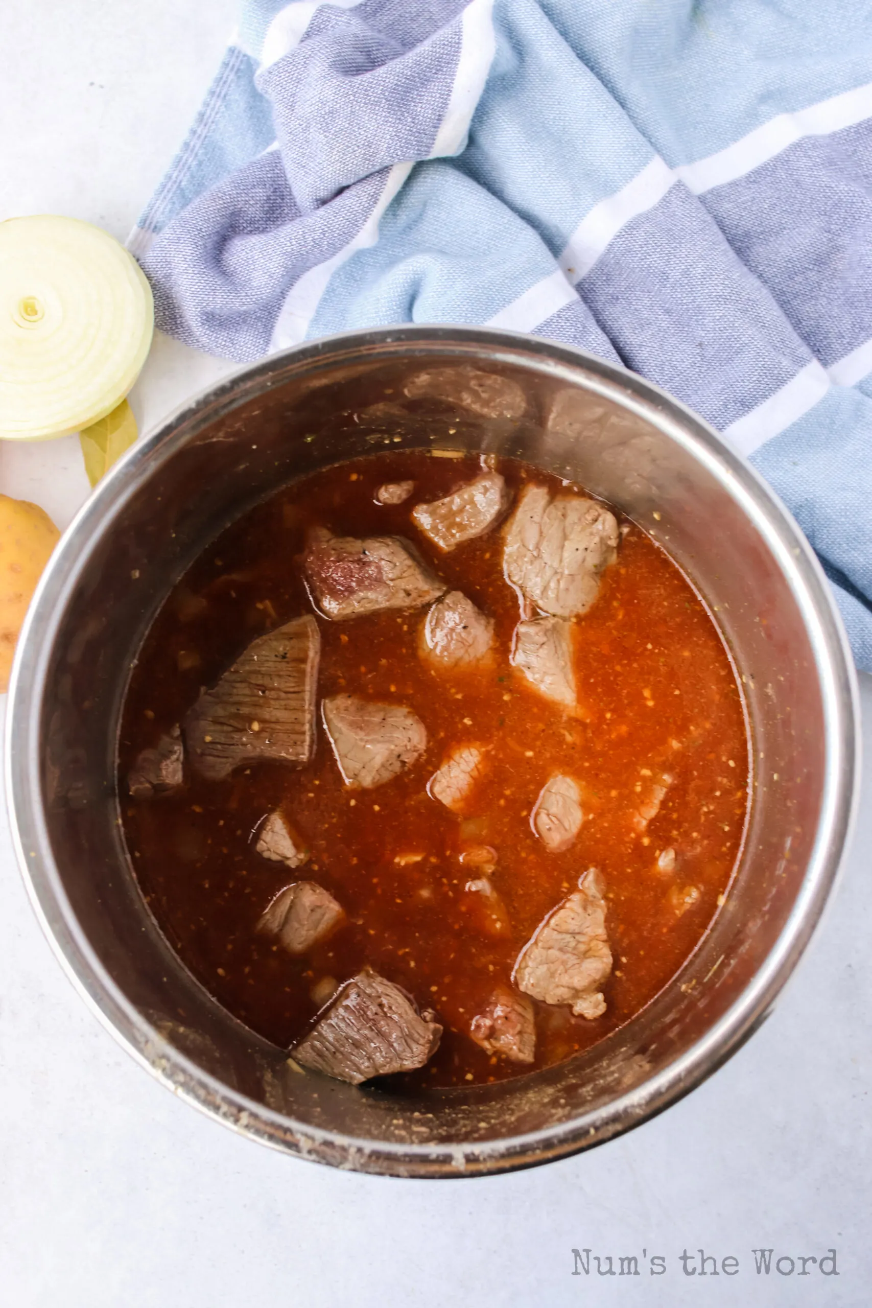 Beef broth, Worcestershire sauce and tomato paste added to instant pot with beef, onions and garlic.