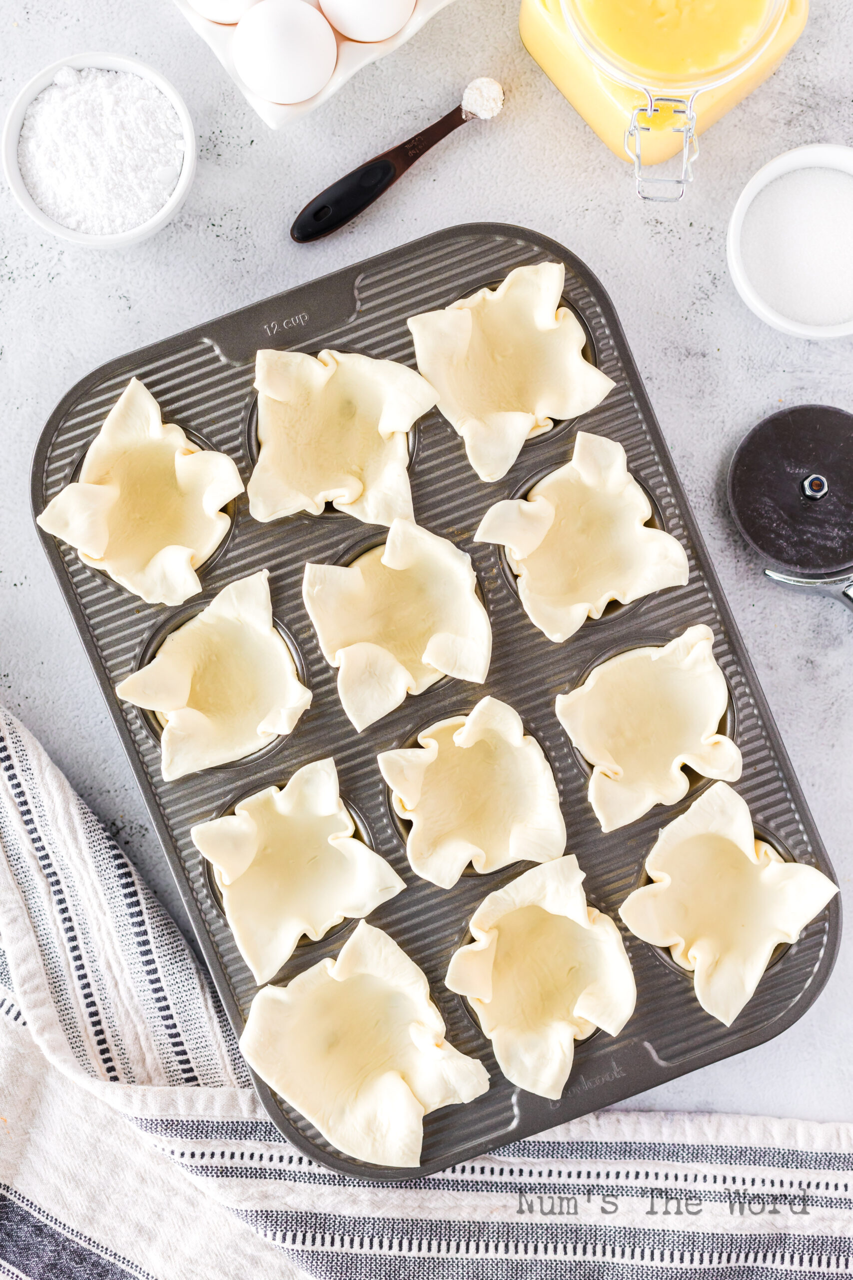 Puff pastry squares placed into muffin tin