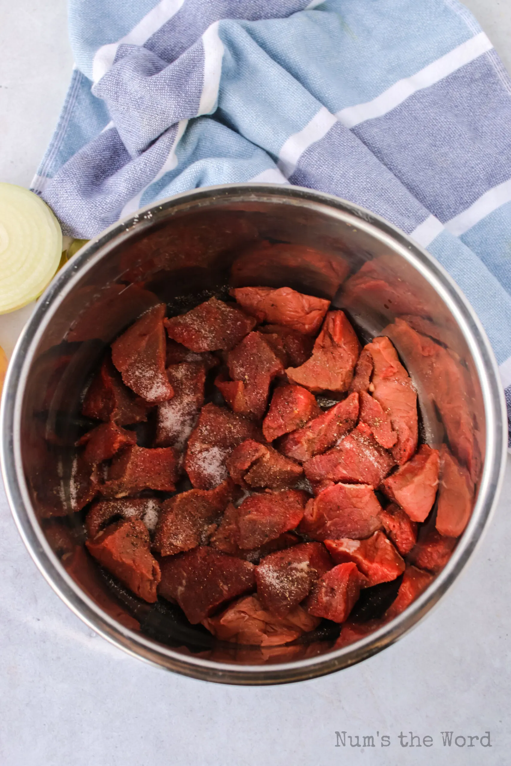 stew beef with salt and pepper in instant pot ready to be seared.