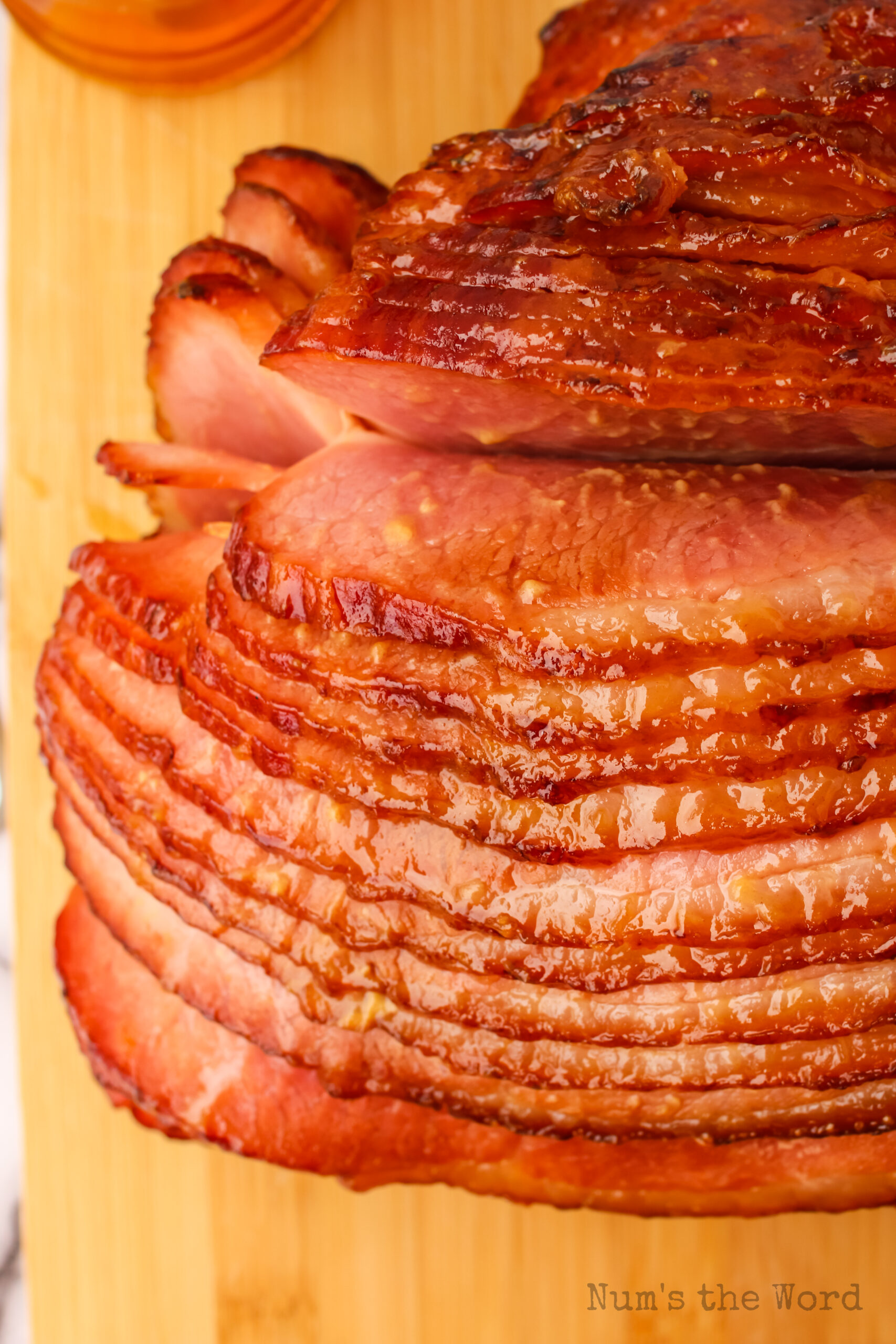 Top side view of ham slices spread out on cutting board