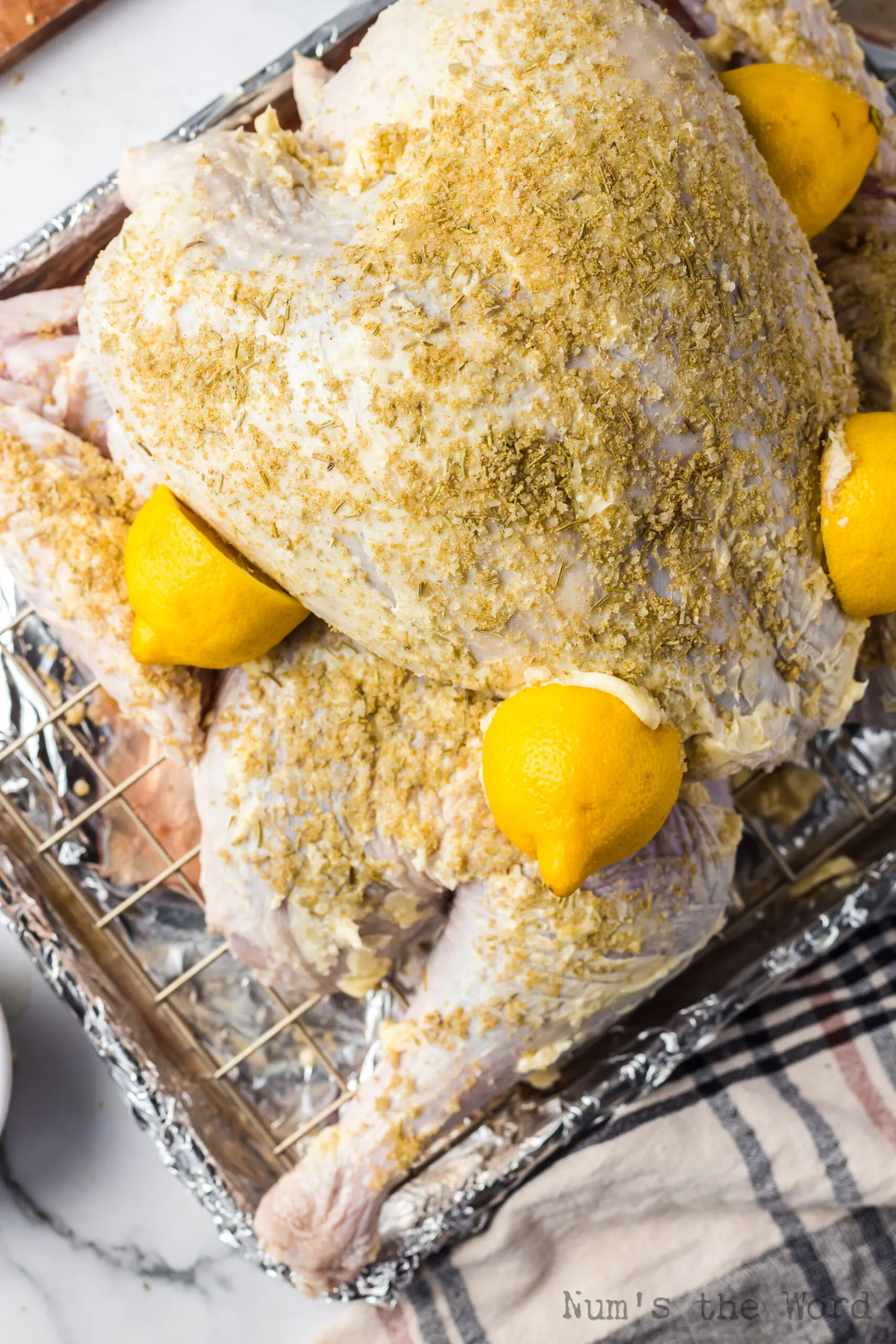 two lemons cut in half and stuck onto turkey via butter.