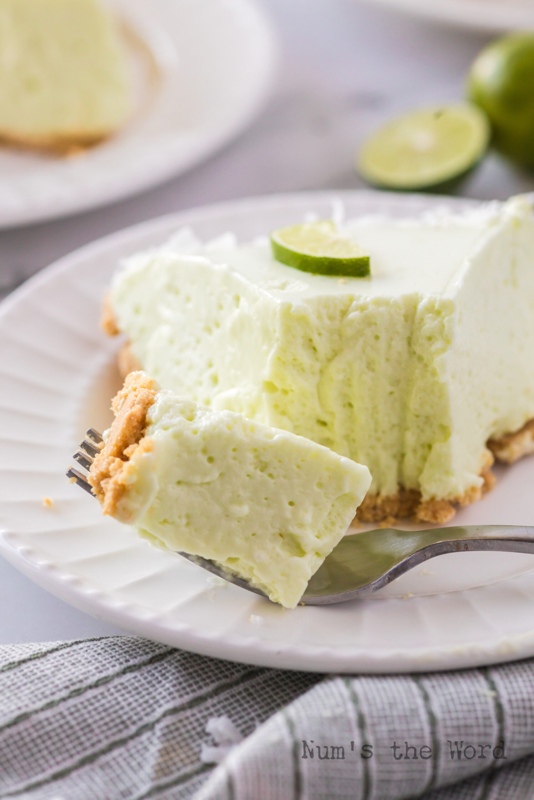 A slice of chiffon pie on plate with a fork full