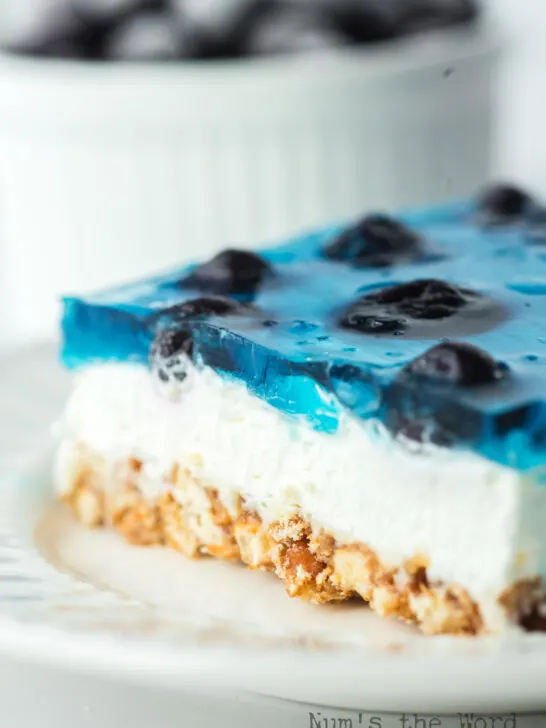 zoomed in image of a slice of Blueberry jello salad with pretzels on a palte