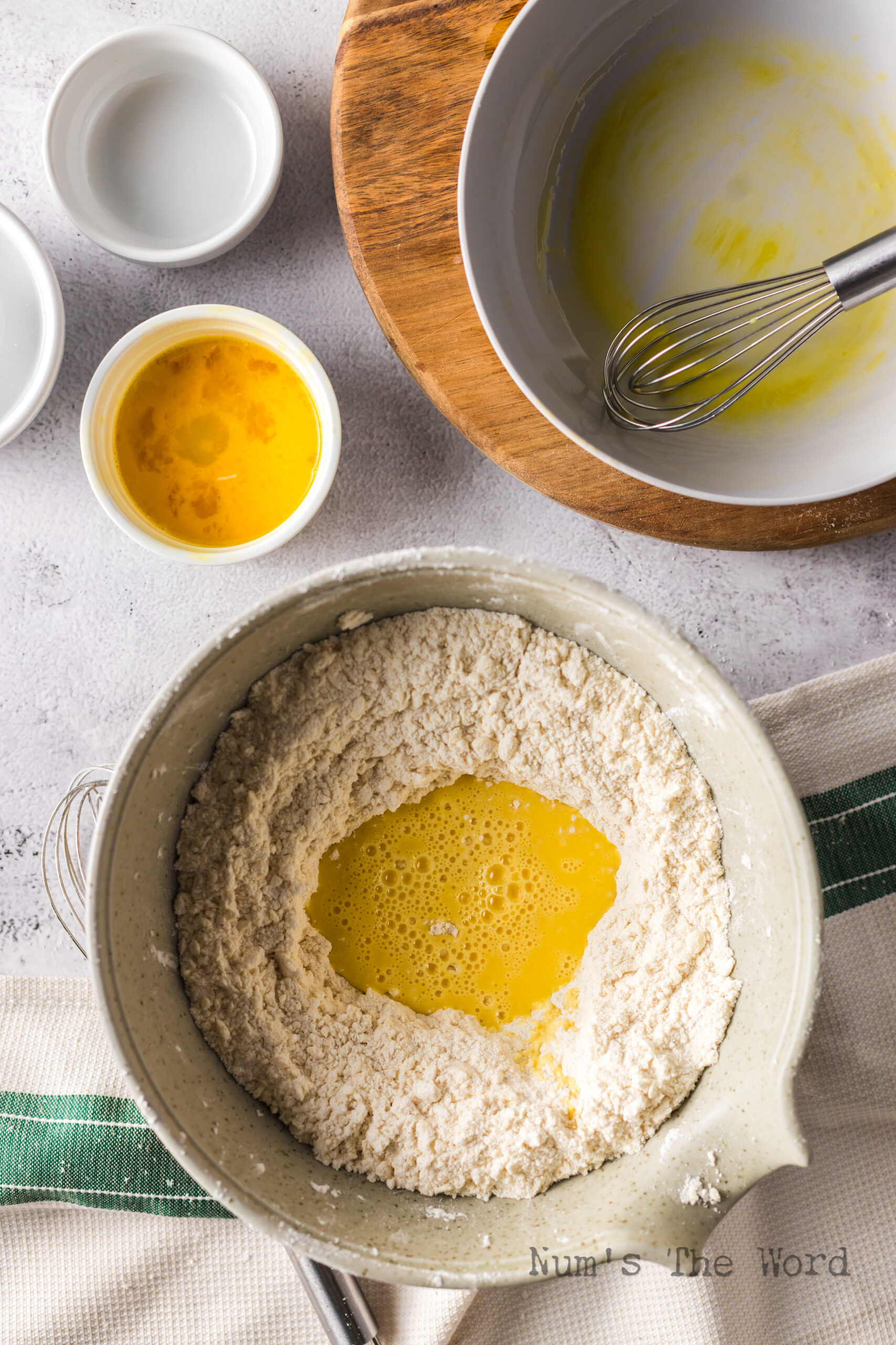 egg yolks, water and vinegar added to the center of flour and butter mixture.