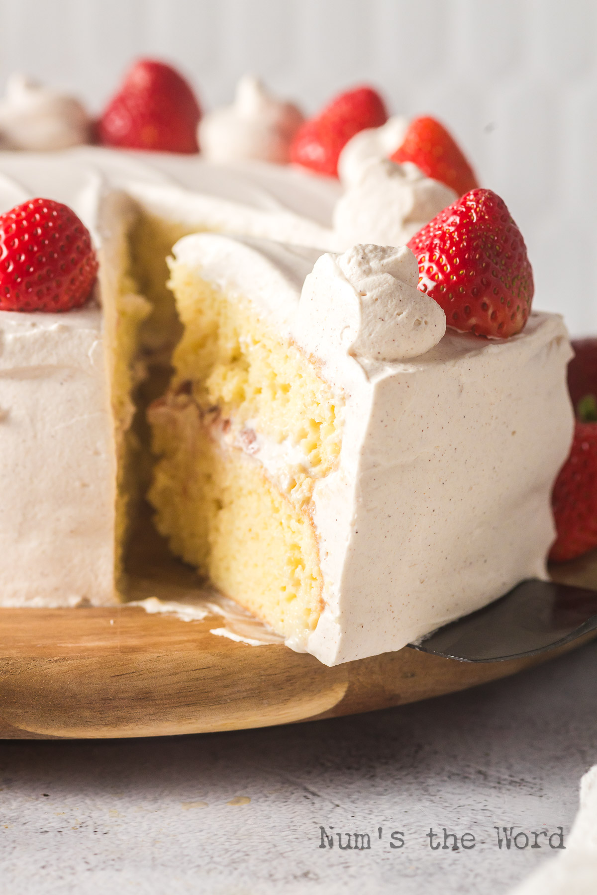 A slice cut out of the cake and tipped back to show filling