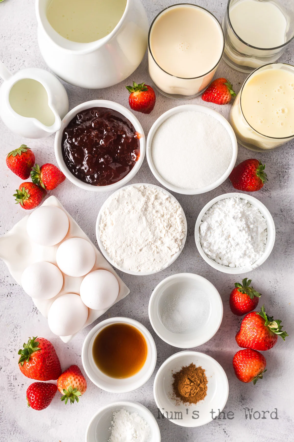 All ingredients laid out on counter, ready to make tres leches cake with strawberries