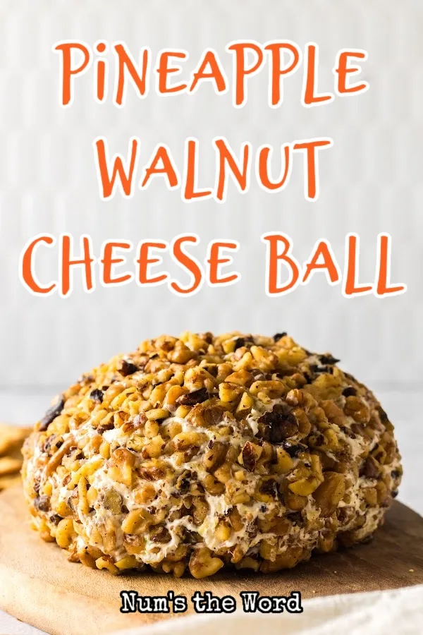 Main image for Pineapple Walnut Cheese Ball. Side view of cheeseball on a wooden board.