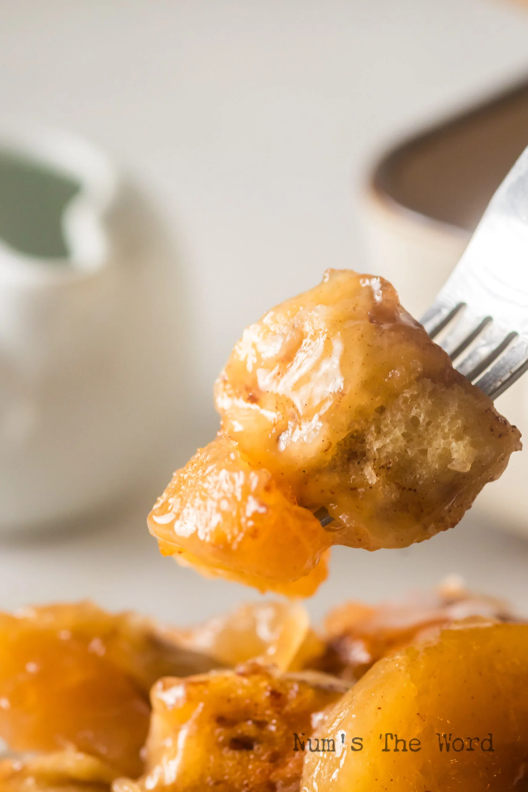 Fork scooping up a portion of cinnamon roll casserole