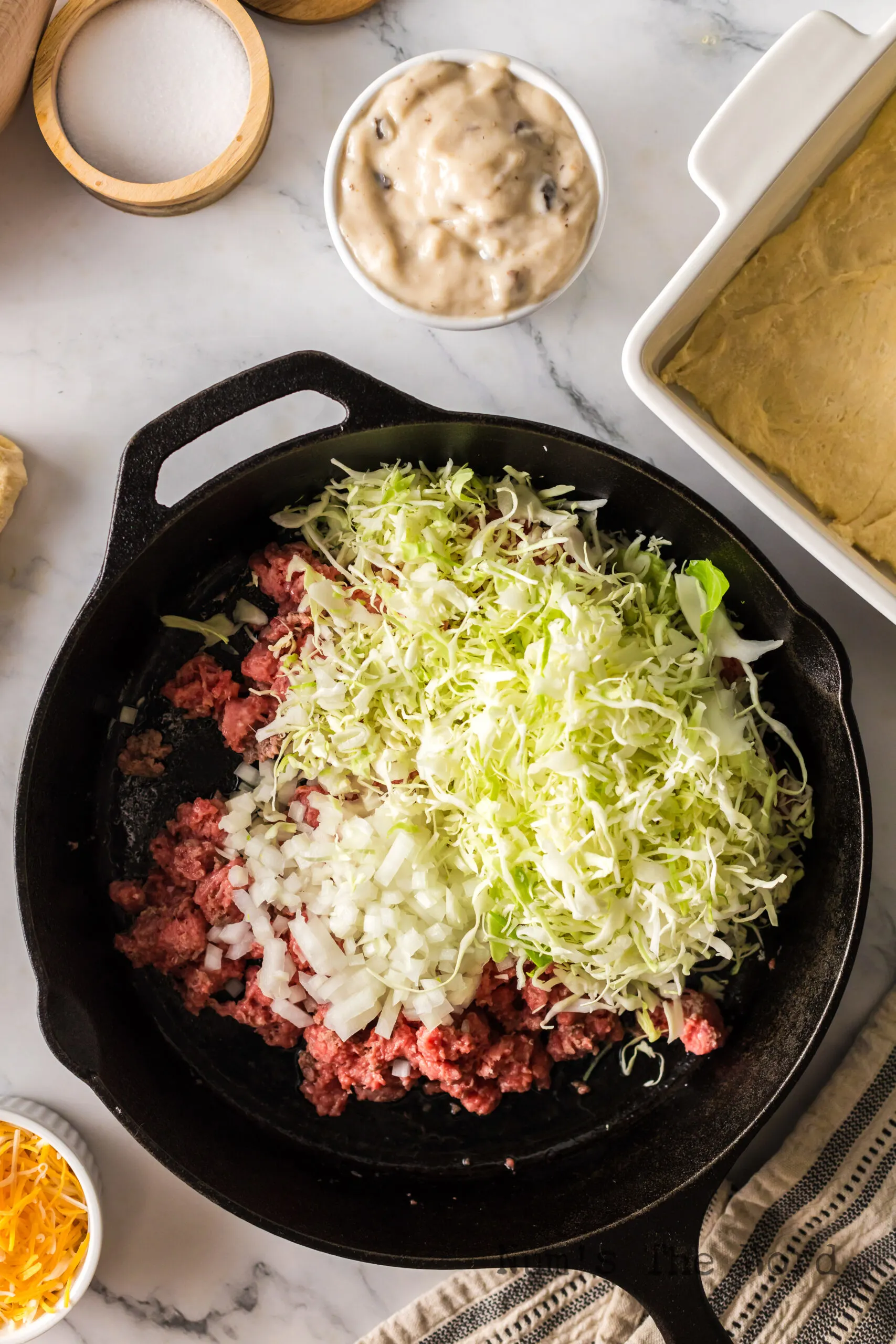ground beef onion and cabbage in a skillet, uncooked.