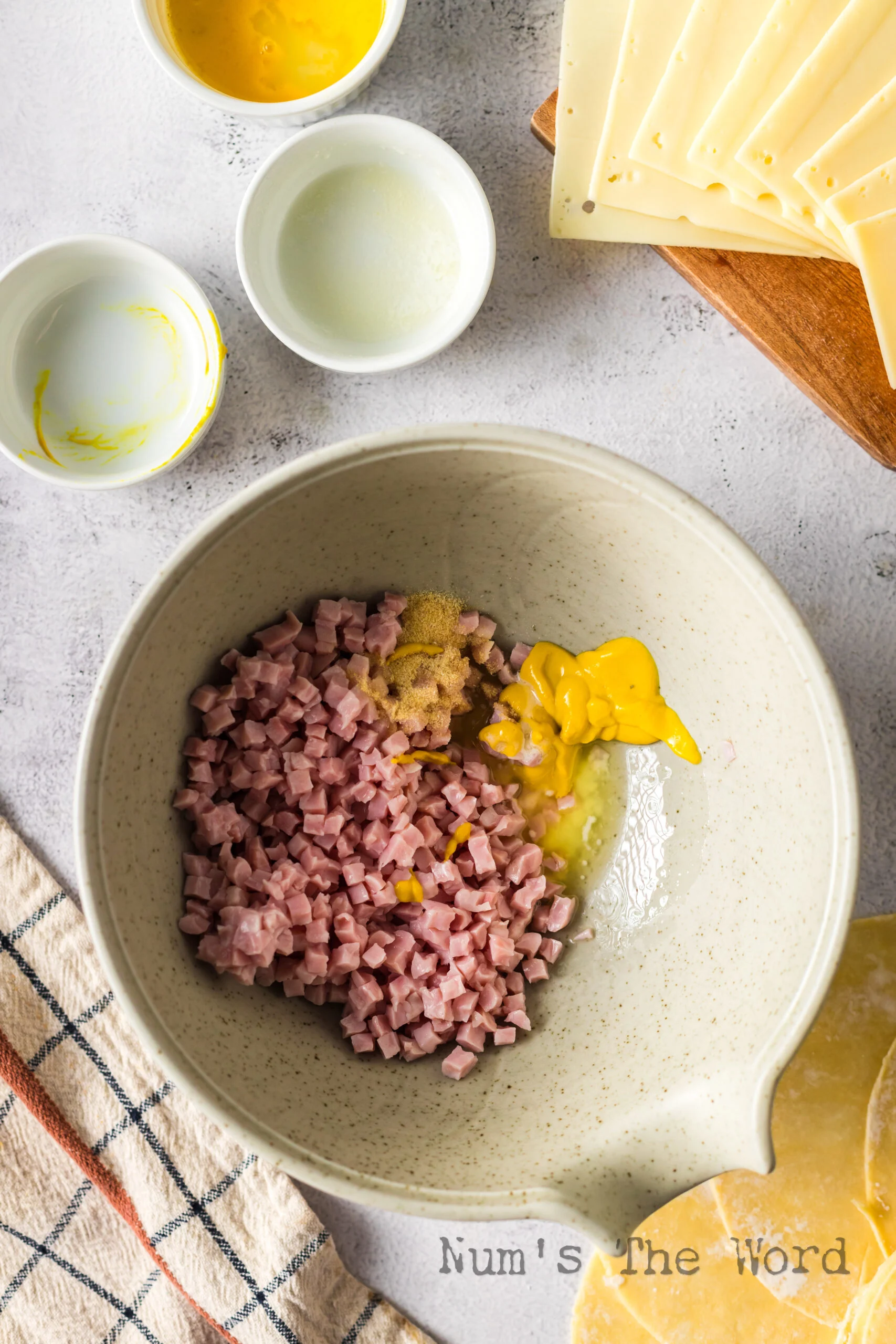 ham, mustard, butter and onion powder in a bowl unmixed.