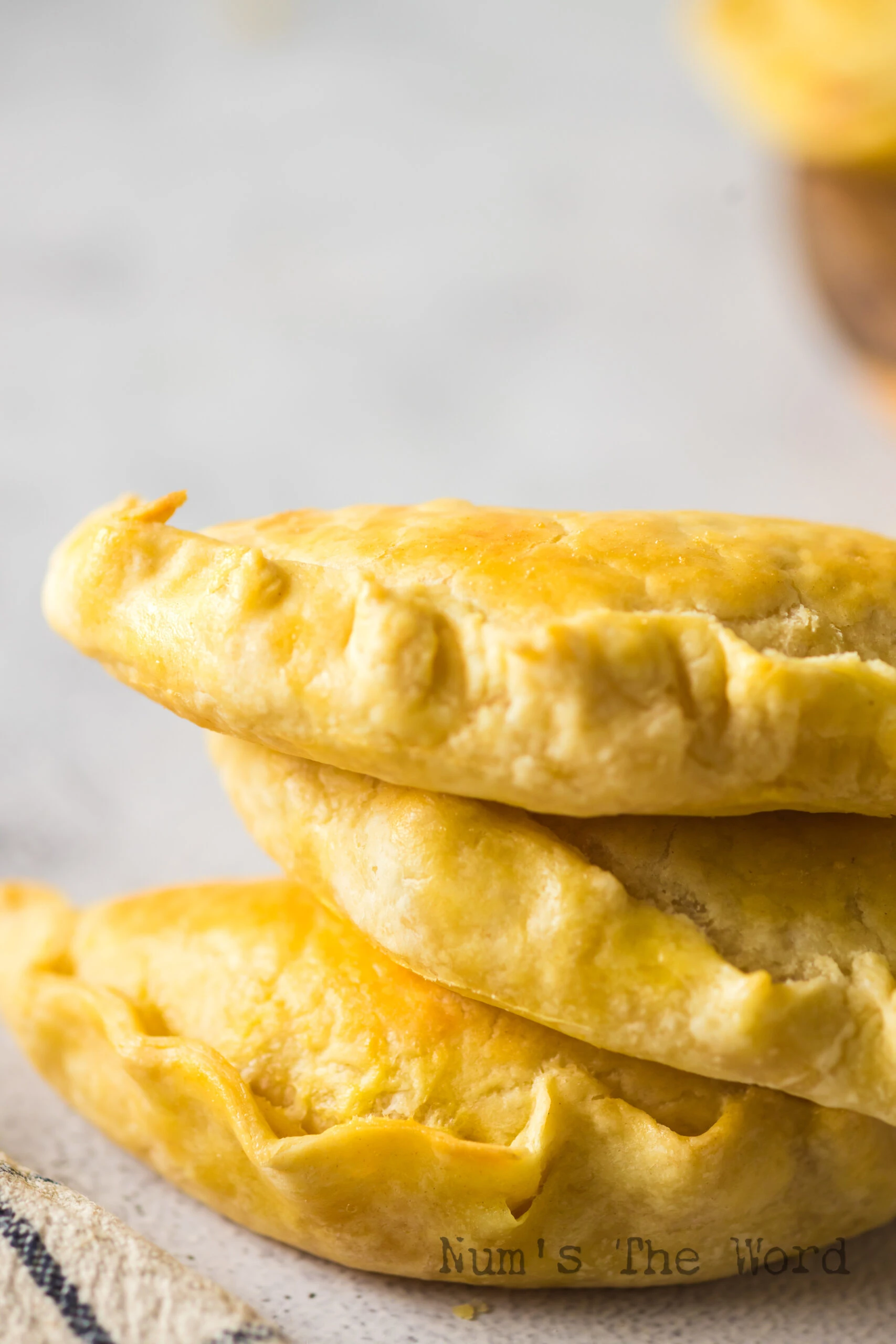 baked empanadas on counter stacked up on top of each other.