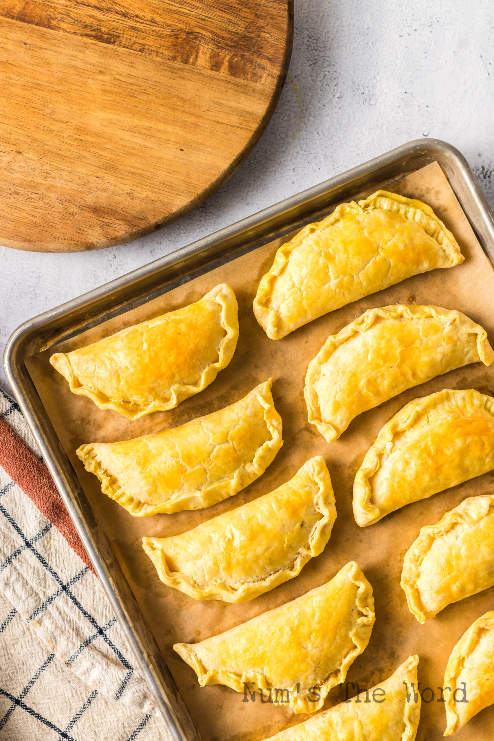 Baked empanadas on baking sheet fresh from the oven.