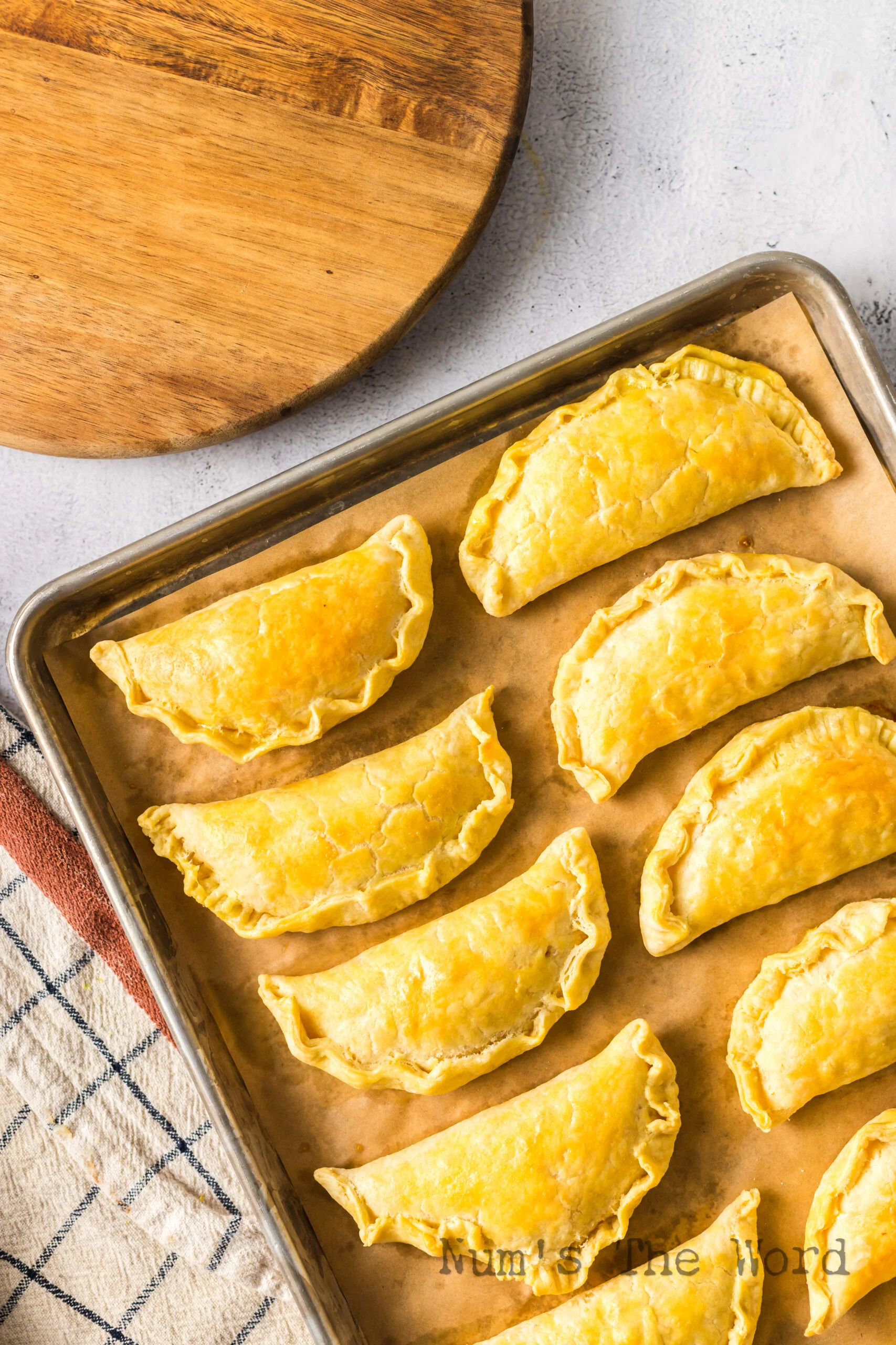 Baked empanadas on baking sheet fresh from the oven.