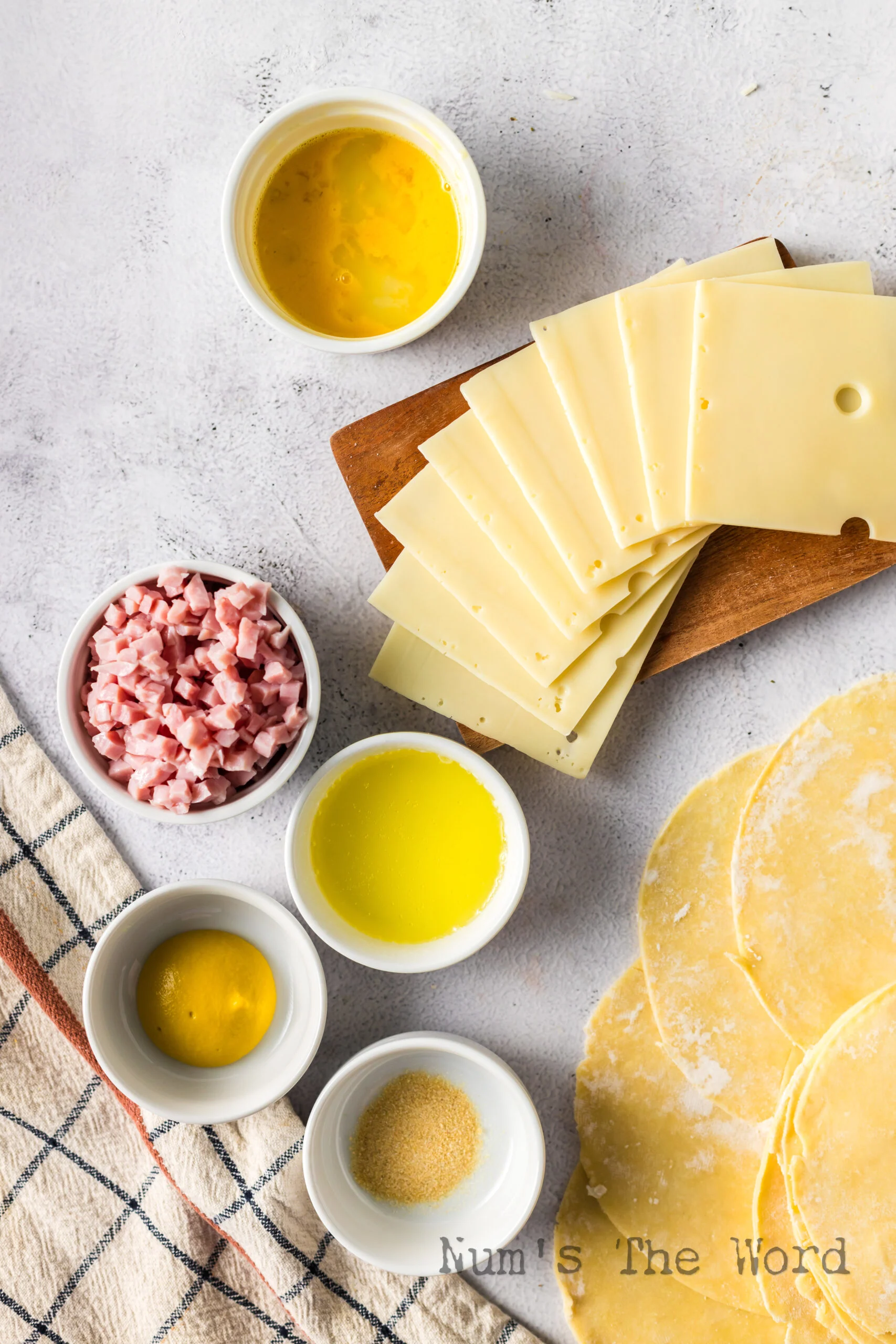 all ingredients for ham and cheese empanadas laid out on the counter.