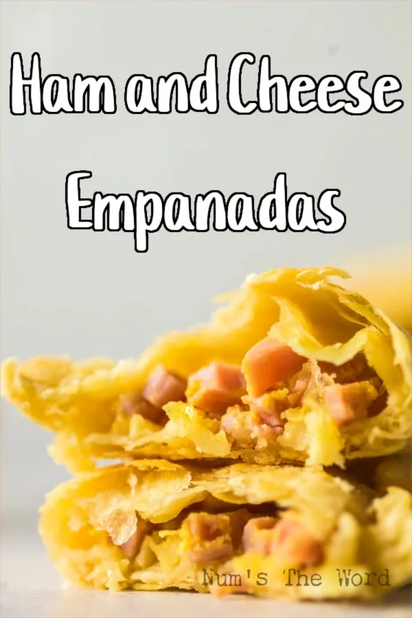 Main image for Ham and Cheese Empanadas. Empanada is cut in half to show filling.