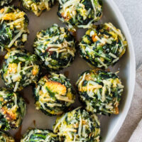 baked spinach balls laid out on serving platter.