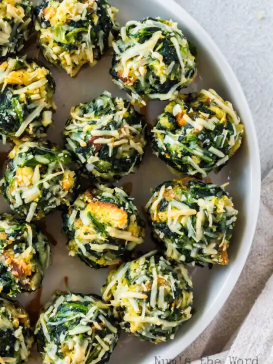 baked spinach balls laid out on serving platter.