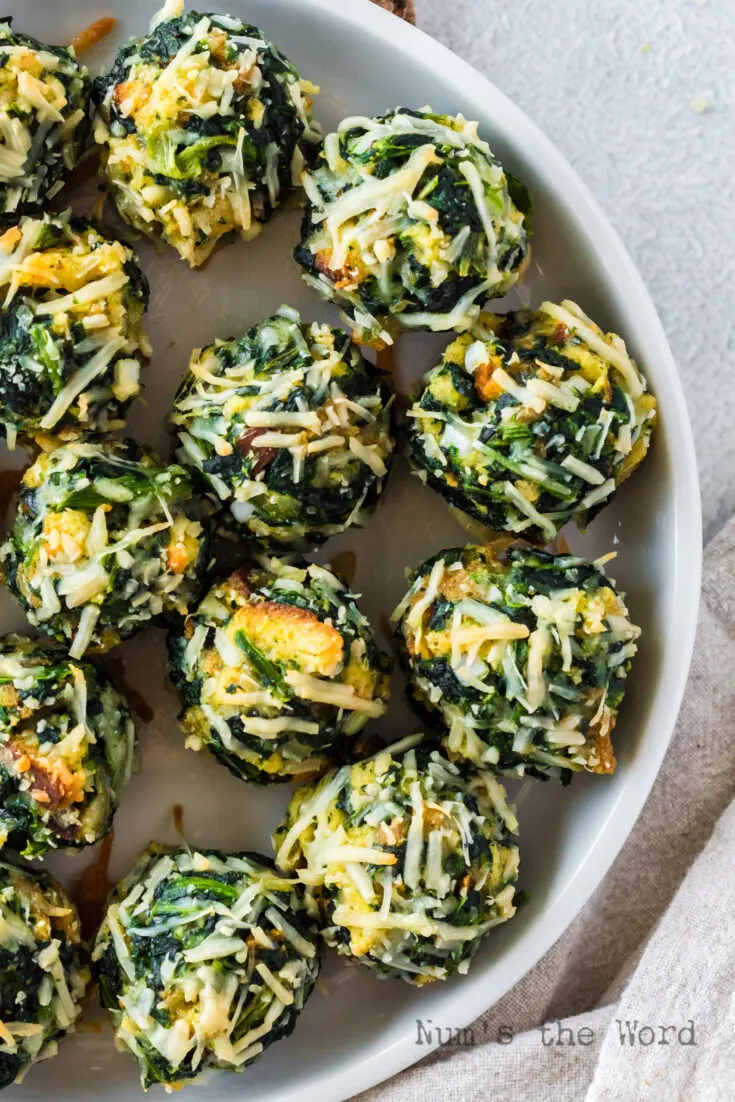 baked spinach balls laid out on serving platter.
