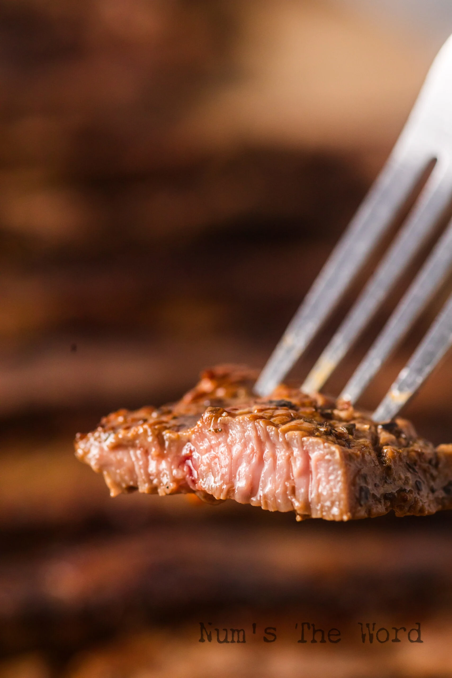 zoomed in image of steak on a fork.