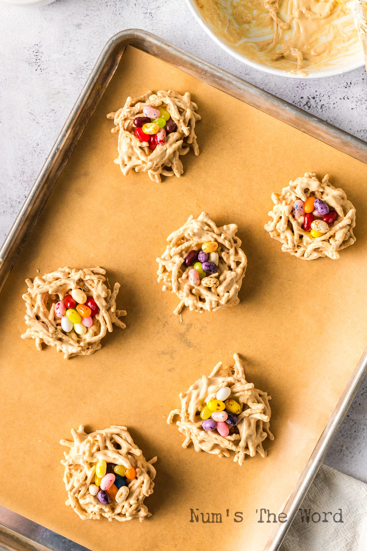 parchment lined baking sheet filled with 6 birds nest cookies.