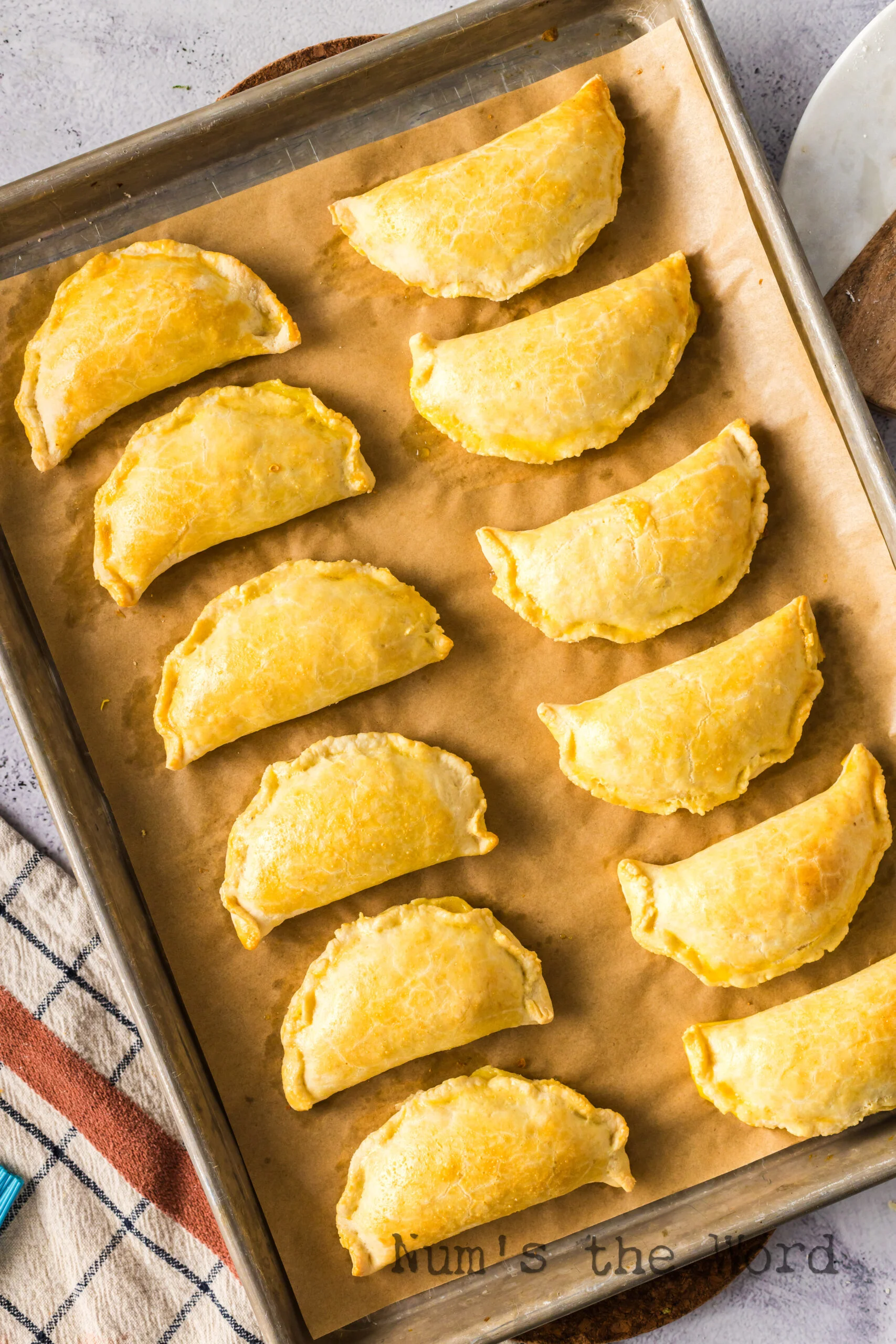 freshly baked empanadas on a baking sheet