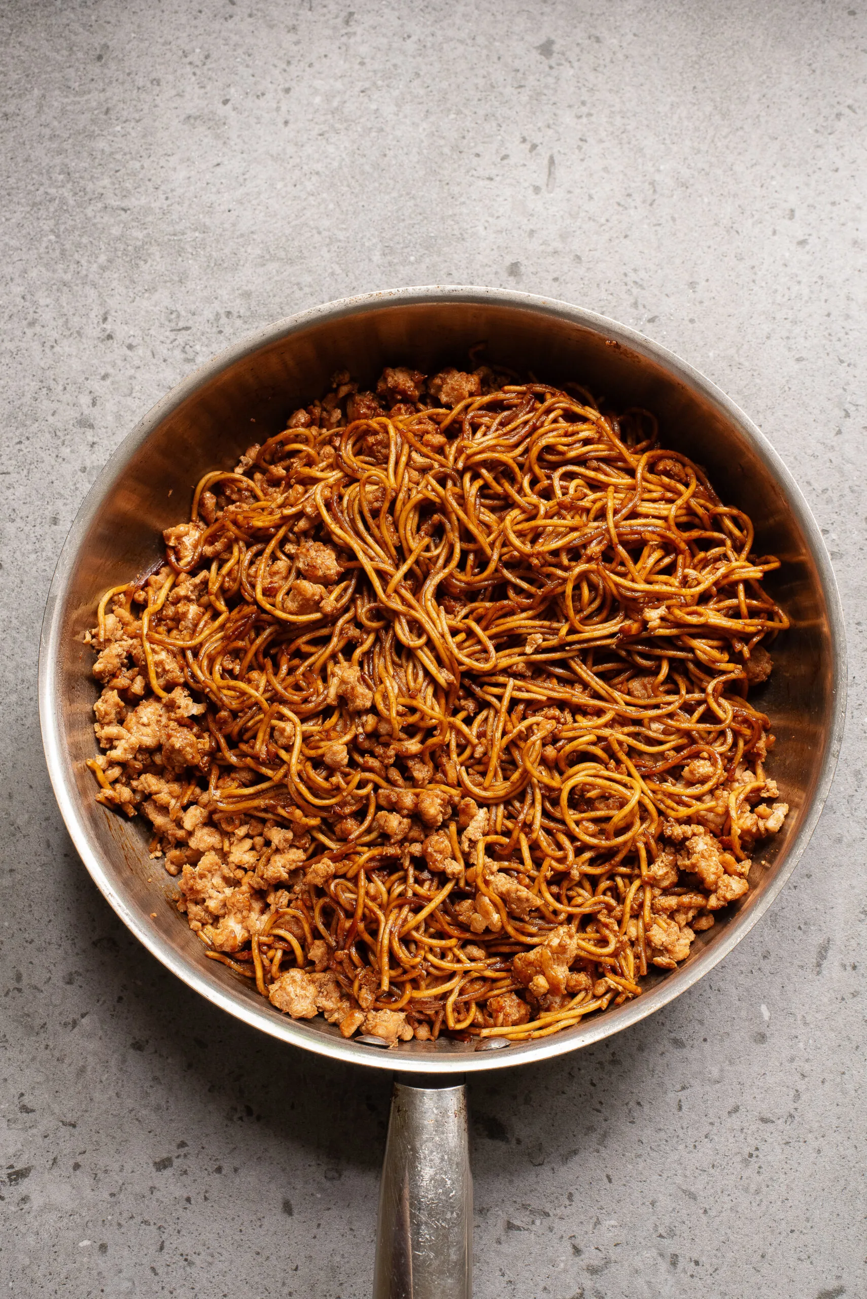 Egg noodles added to chicken with more sauce.