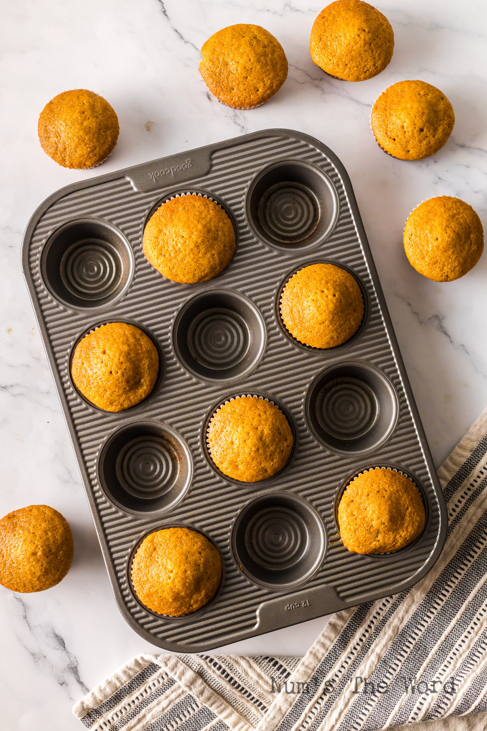 half of the muffins in pan and half the muffins out of the pan for visual effect.