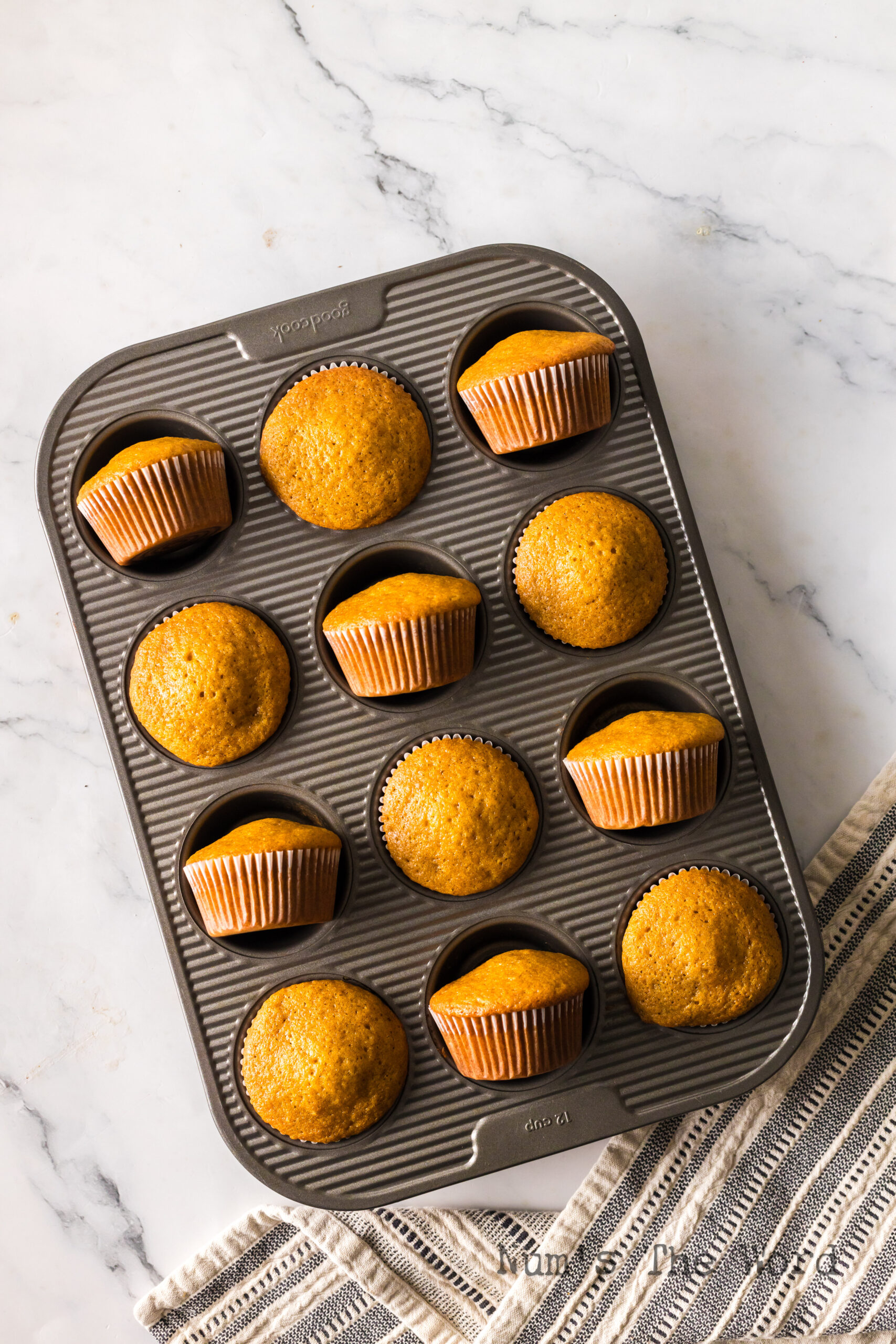muffins baked and in pan. half the muffins are tipped up on their side.
