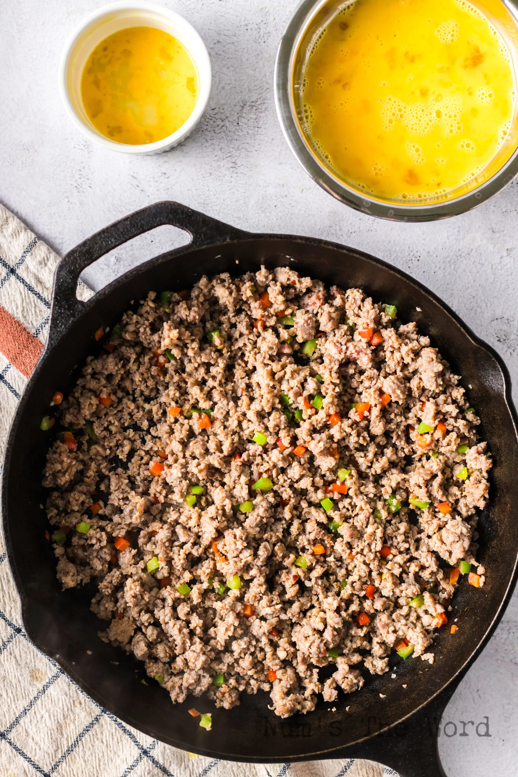 breakfast sausage and peppers cooked in a skillet.