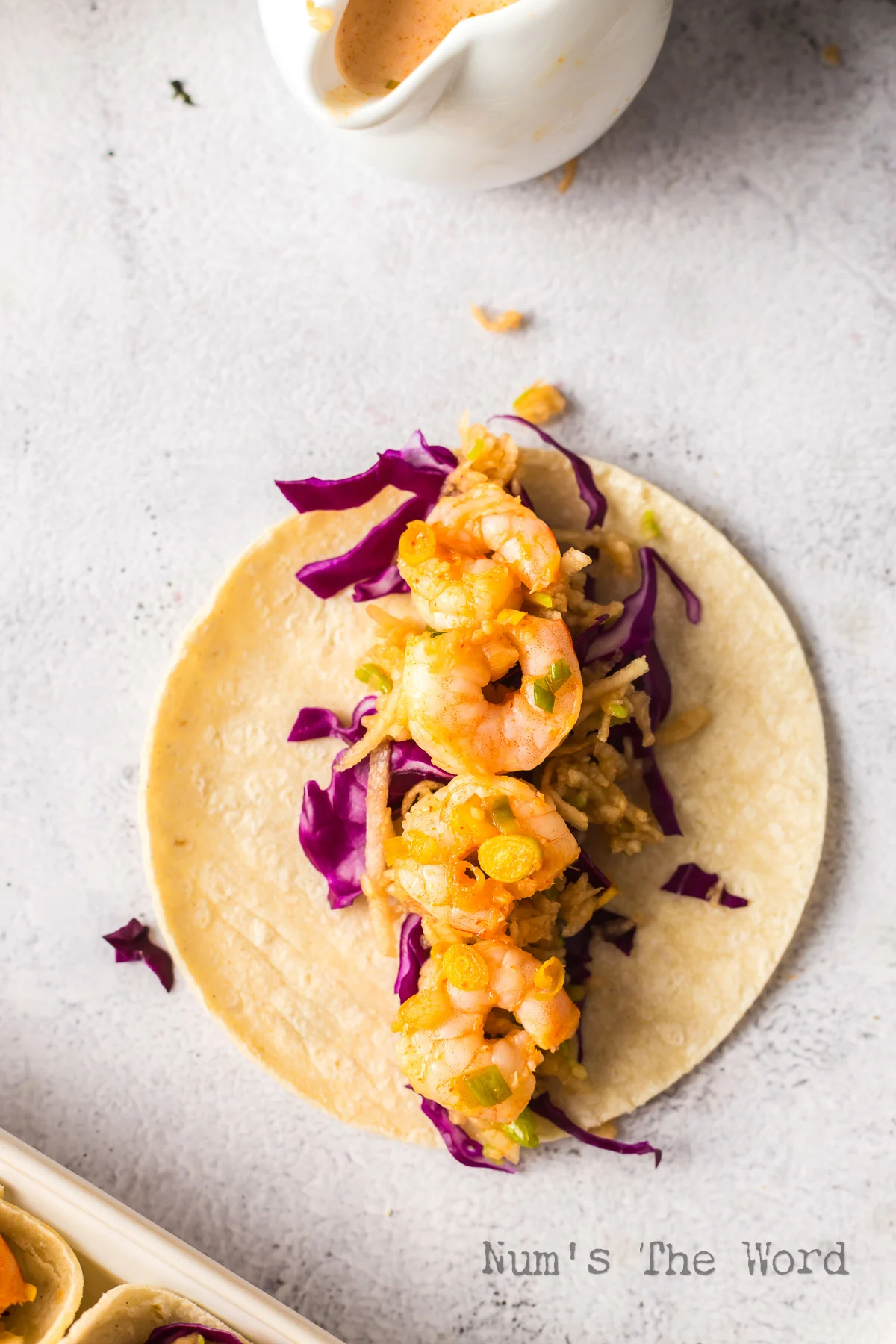 Shrimp laid on top of apple slaw.