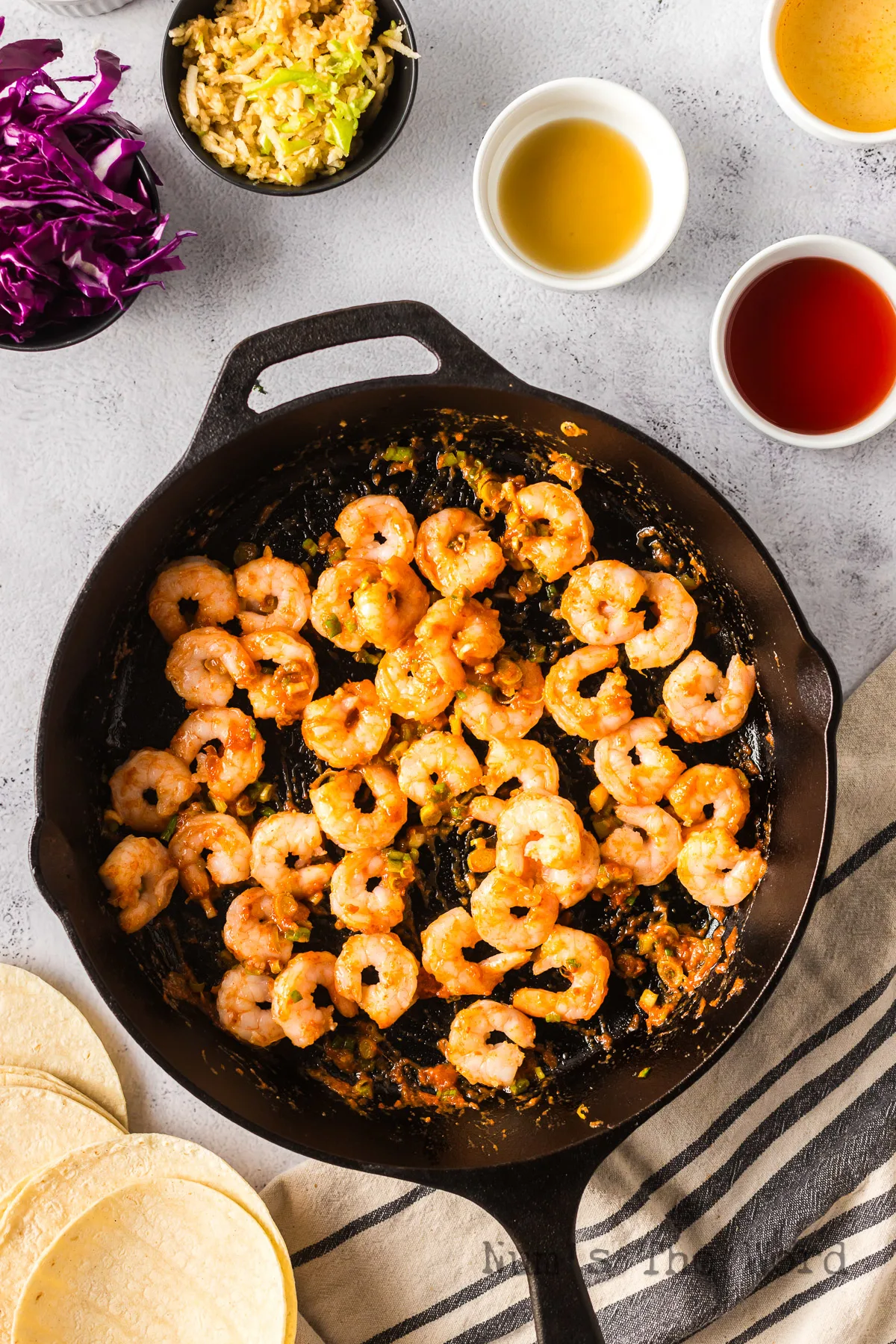shrimp, mirin, plum vinegar and fish sauce added to skillet.