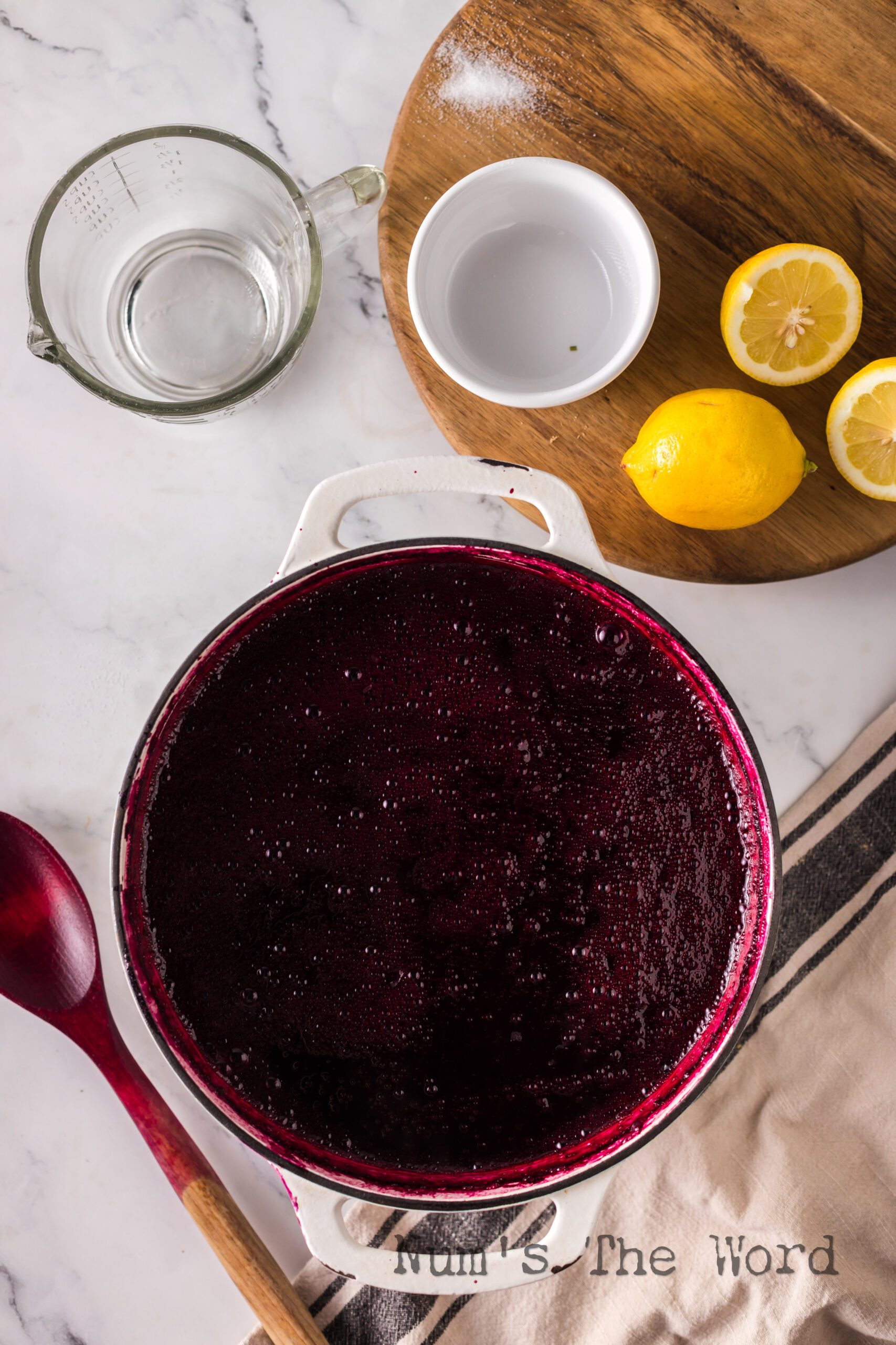Cooked blueberry syrup in a pot.
