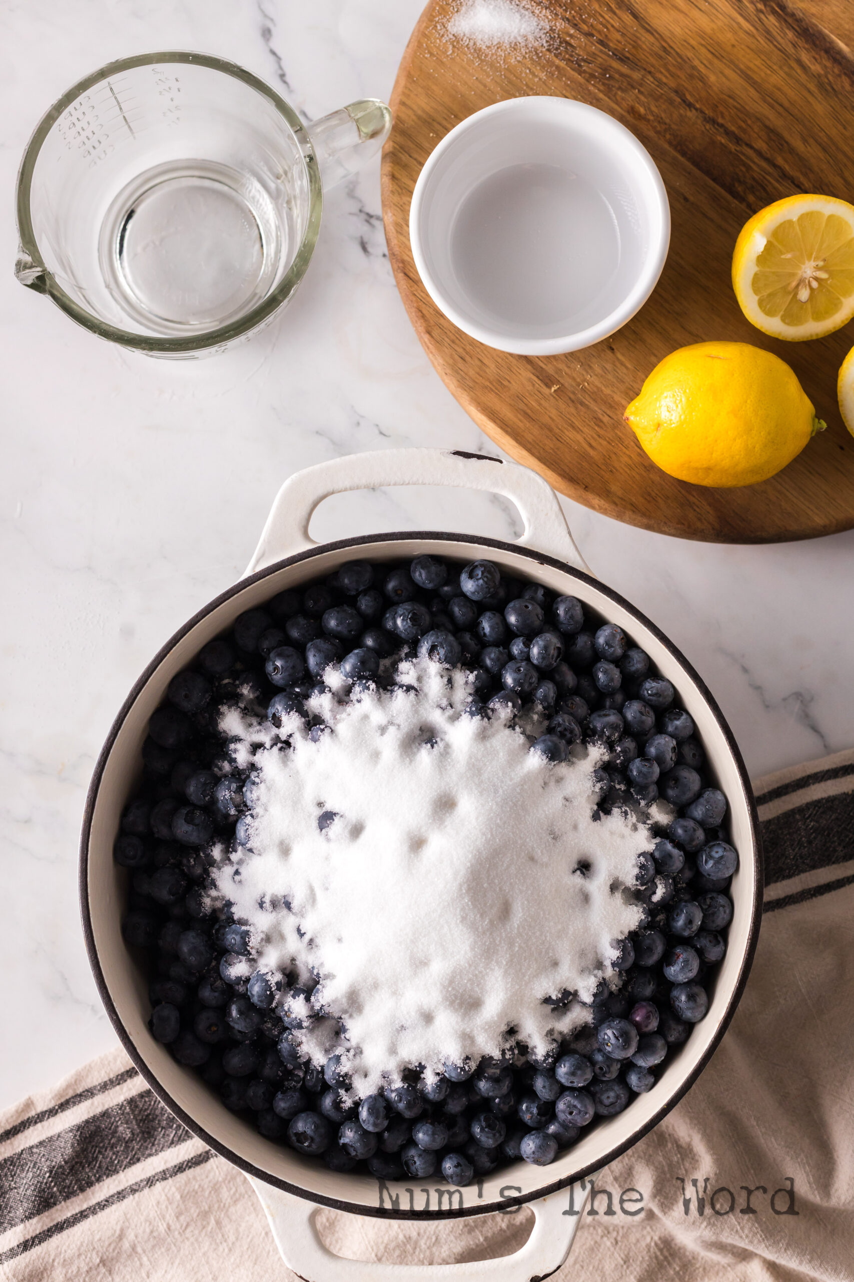 Blueberries, and sugar in a pot