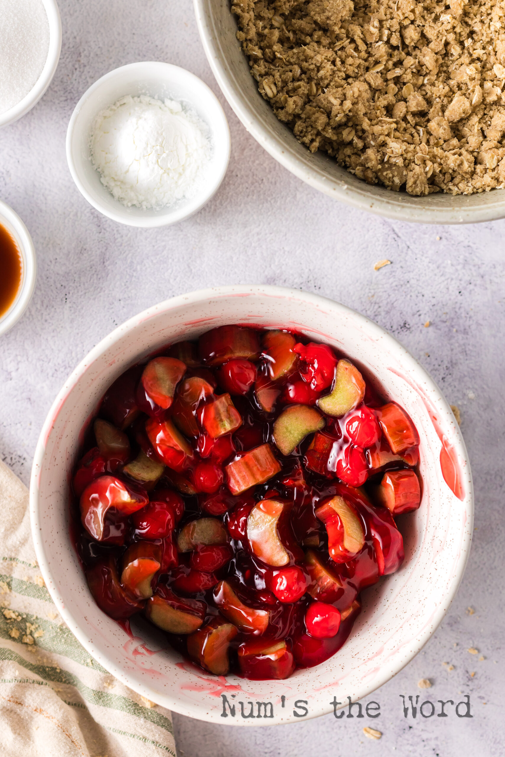 rhubarb and cherry pie filling mixed together in a bowl.